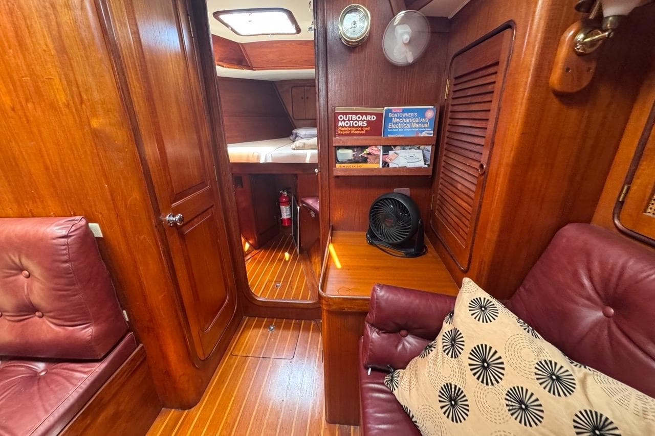 Interior of 1981 Gulfstar 44 Mk II Sloop with wood paneling and leather seating.