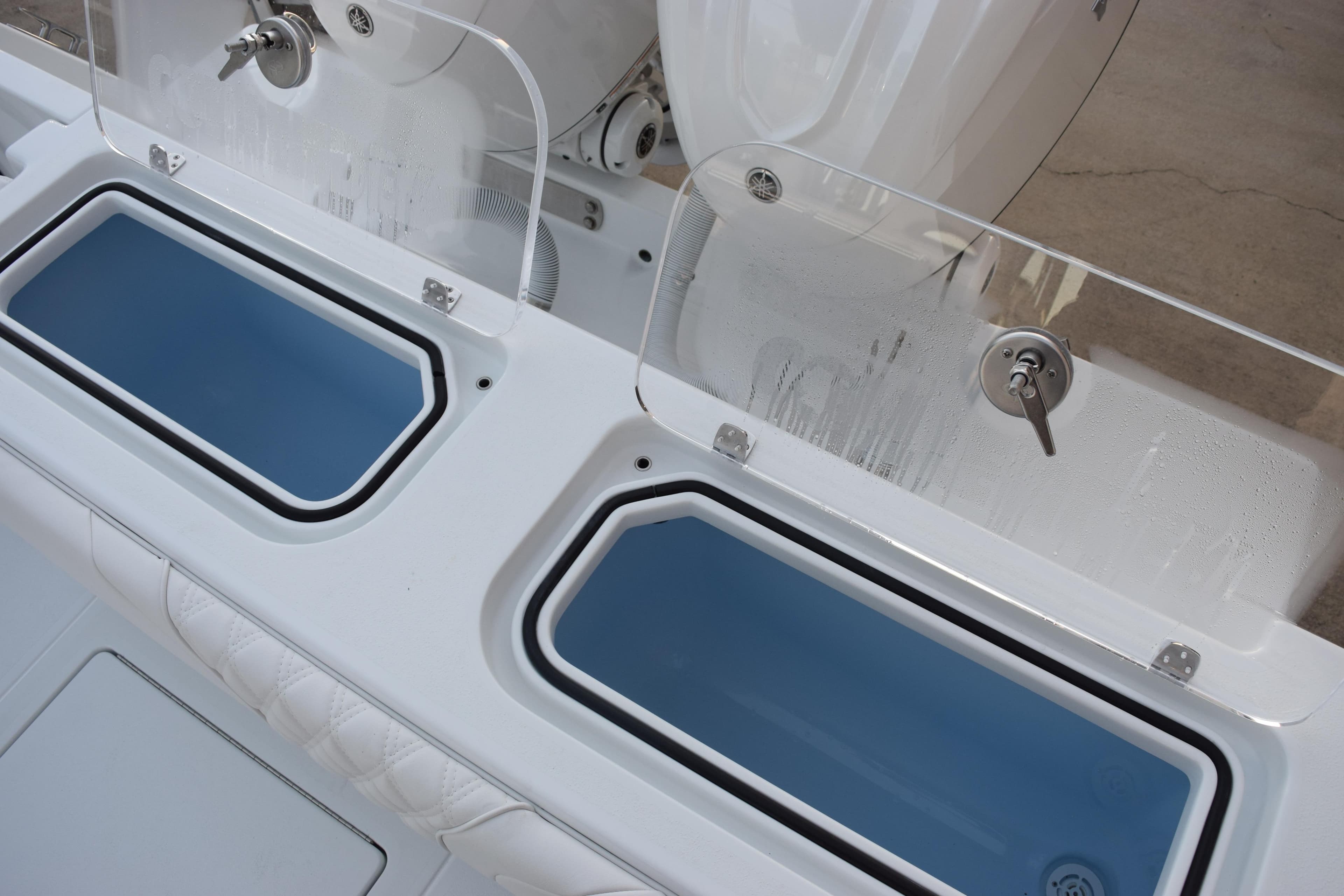 2026 Contender 32 ST boat with dual livewells and clear lids.