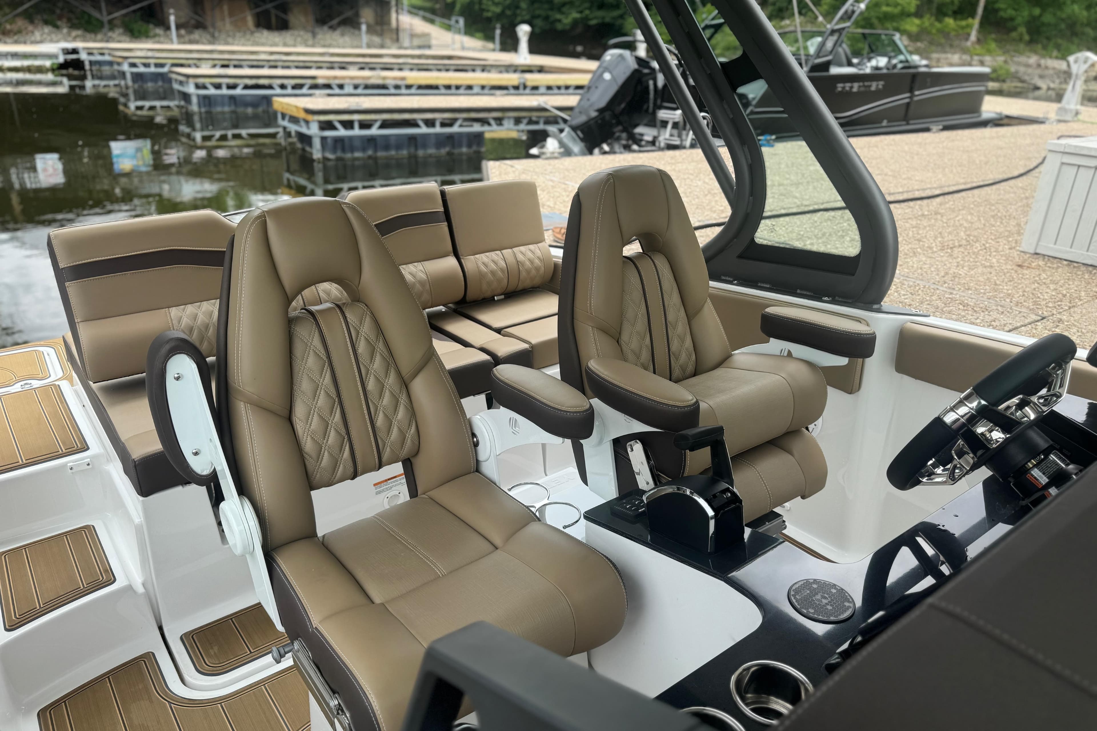 Luxurious interior of 2026 Monterey Elite 25 SD boat with plush seating and modern controls.