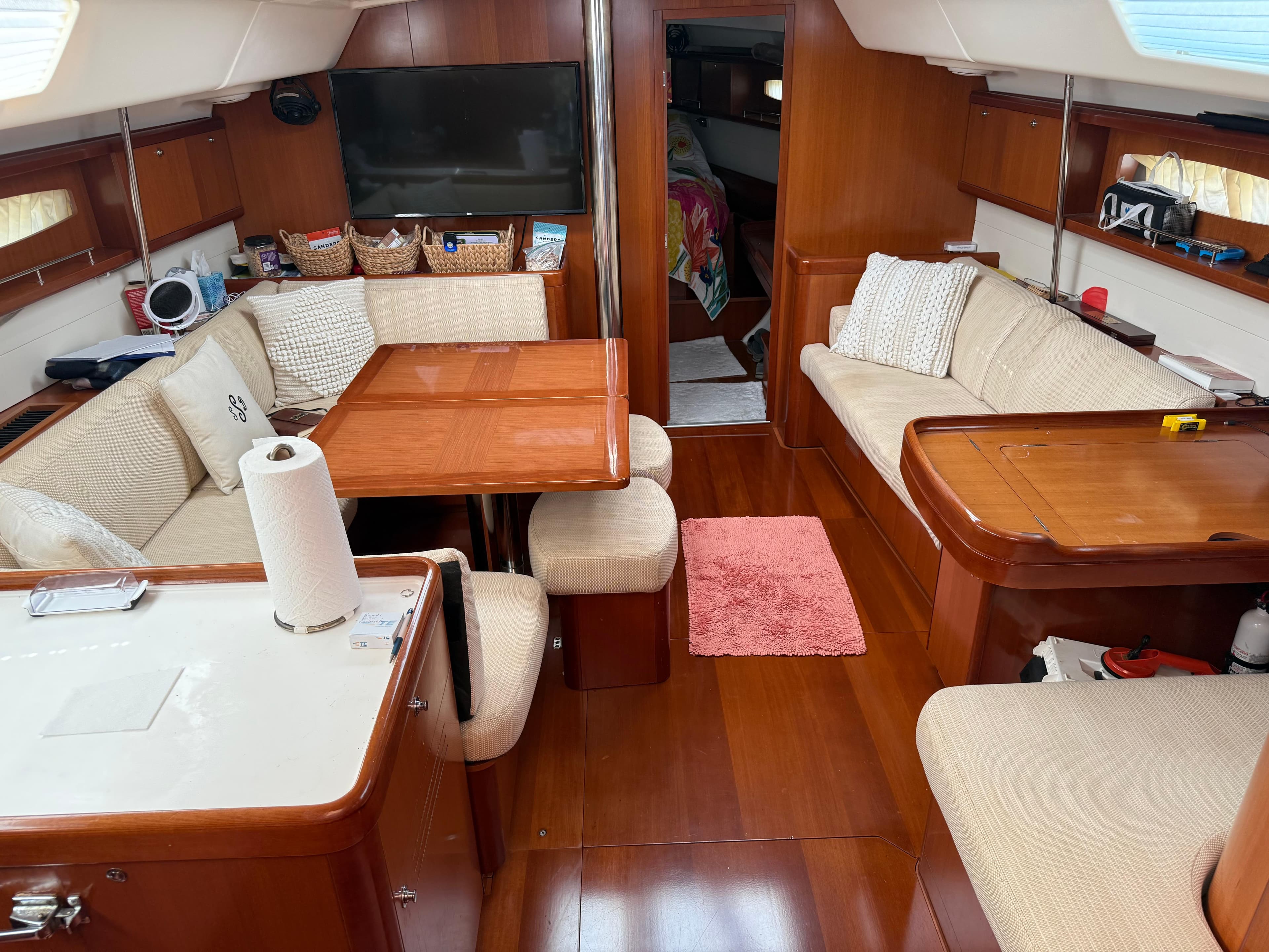 Interior of a 2007 Beneteau 49 yacht with cozy seating and wooden finishes.