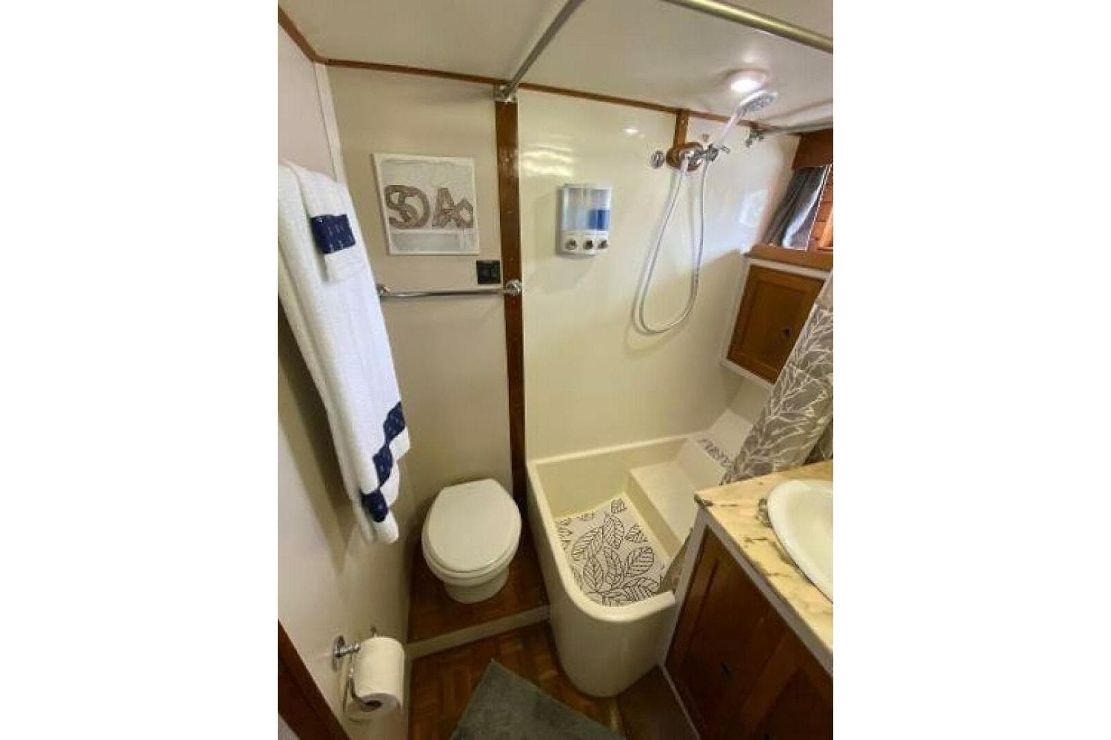 Bathroom of 1973 Grand Banks 49 Alaskan yacht with shower, toilet, and sink.