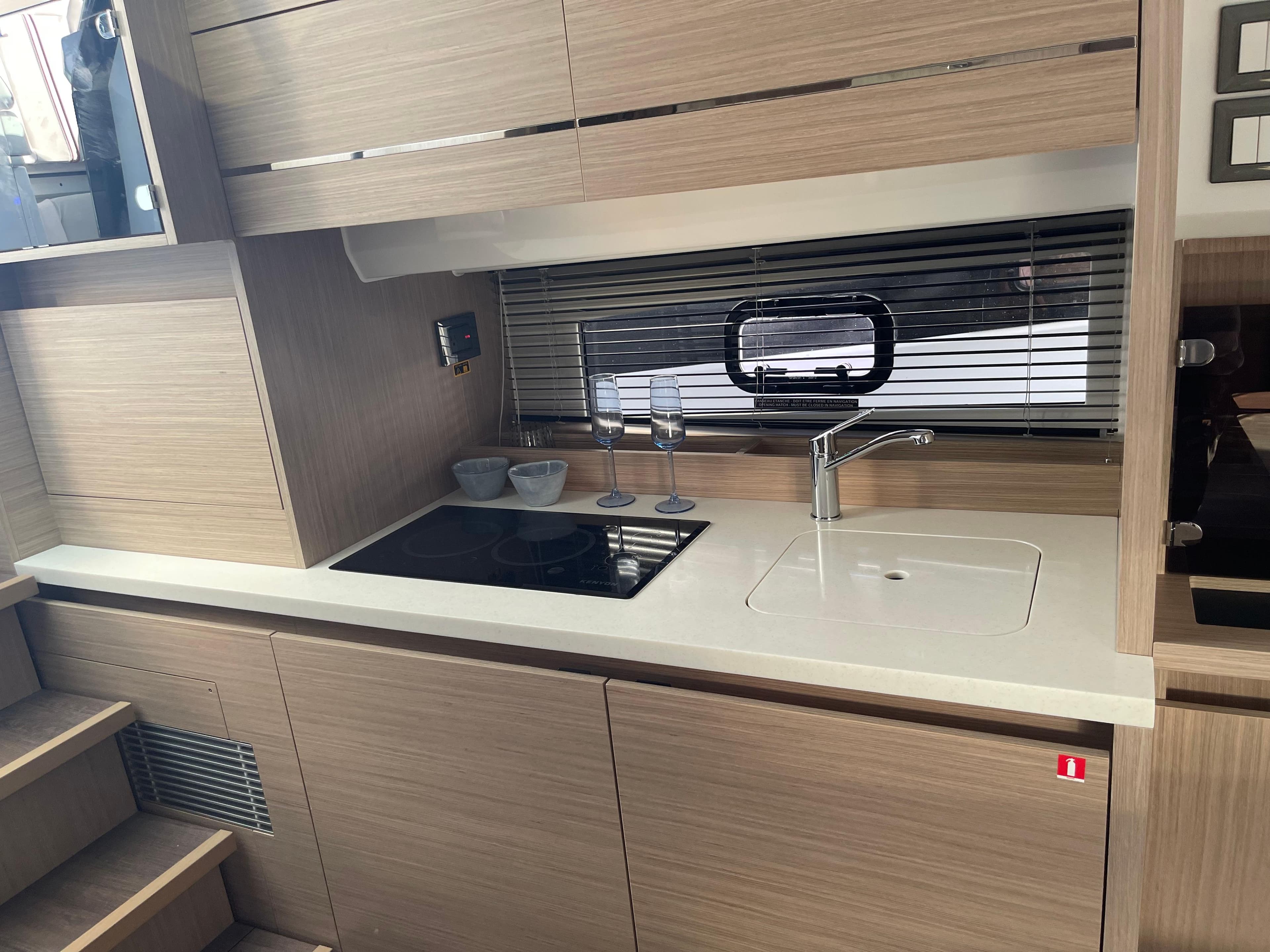 Modern kitchen interior of 2025 Jeanneau Leader 12.5 WA yacht, featuring sleek design and amenities.