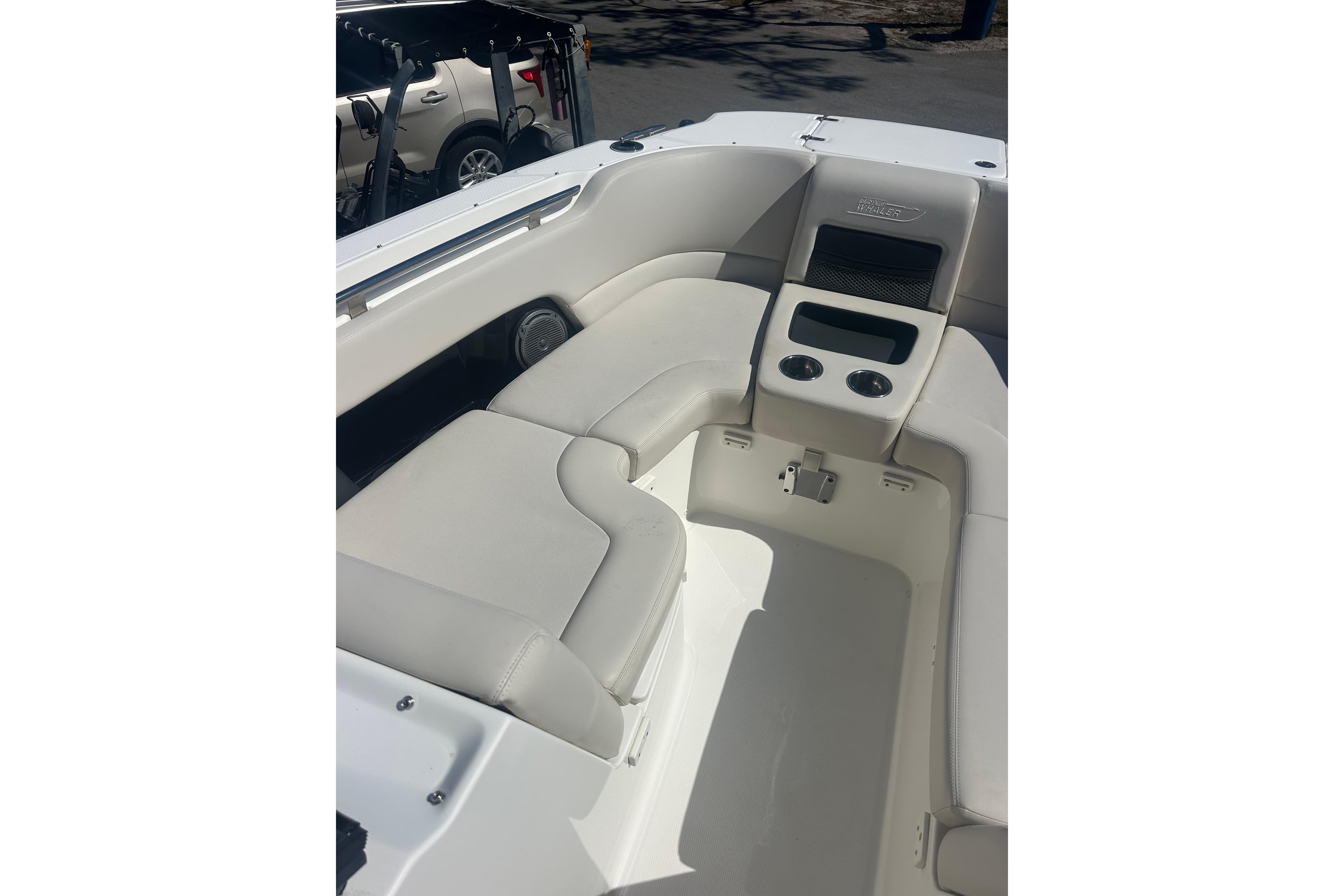 2018 Boston Whaler 270 Vantage boat interior with cushioned seating and cup holders.