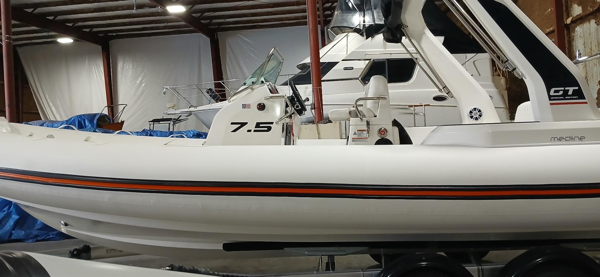2025 Zodiac Medline 7.5 GT boat in storage, side view, indoors.