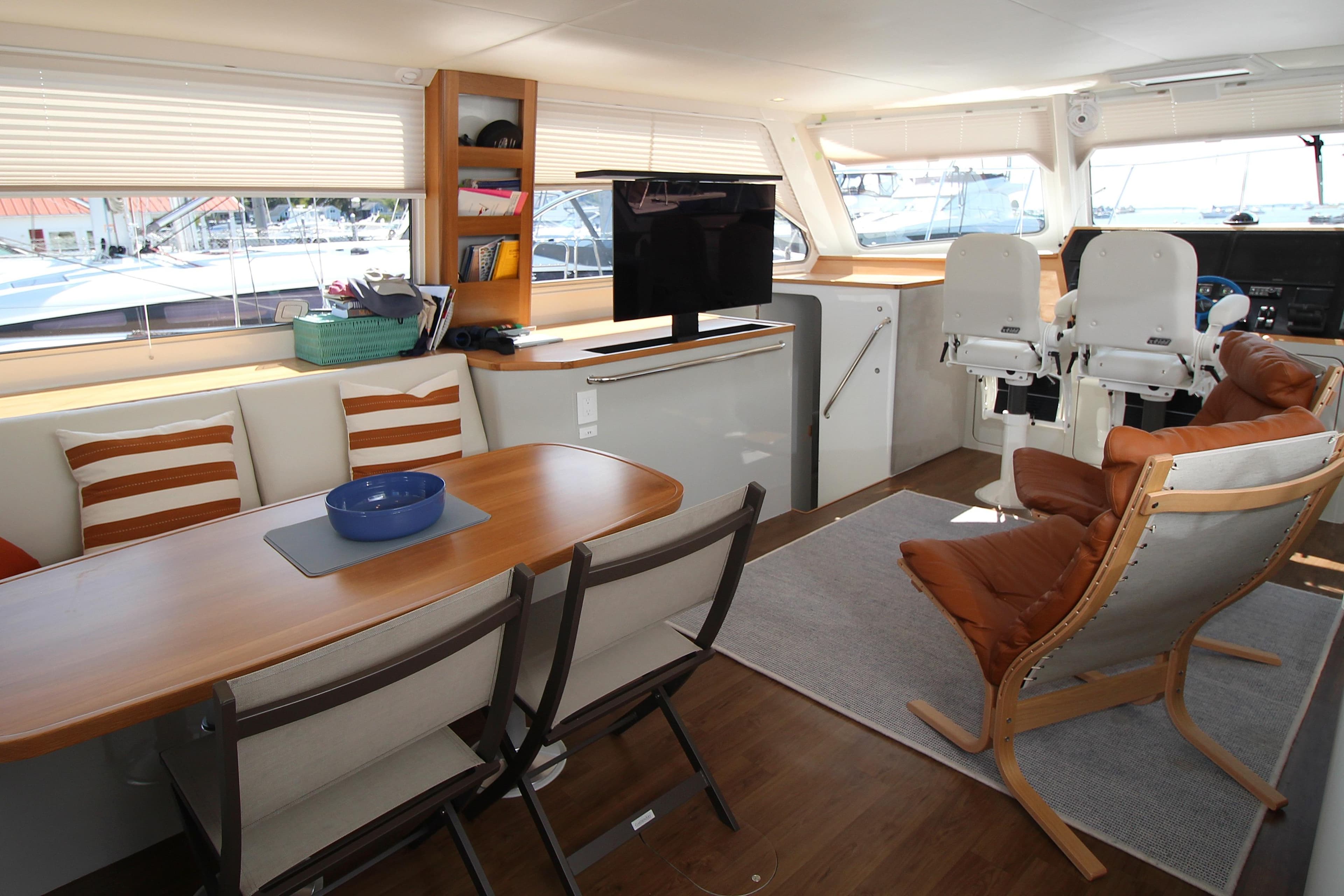 Luxurious interior of 2026 Chris White Spindrift 47 yacht with modern seating and dining area.