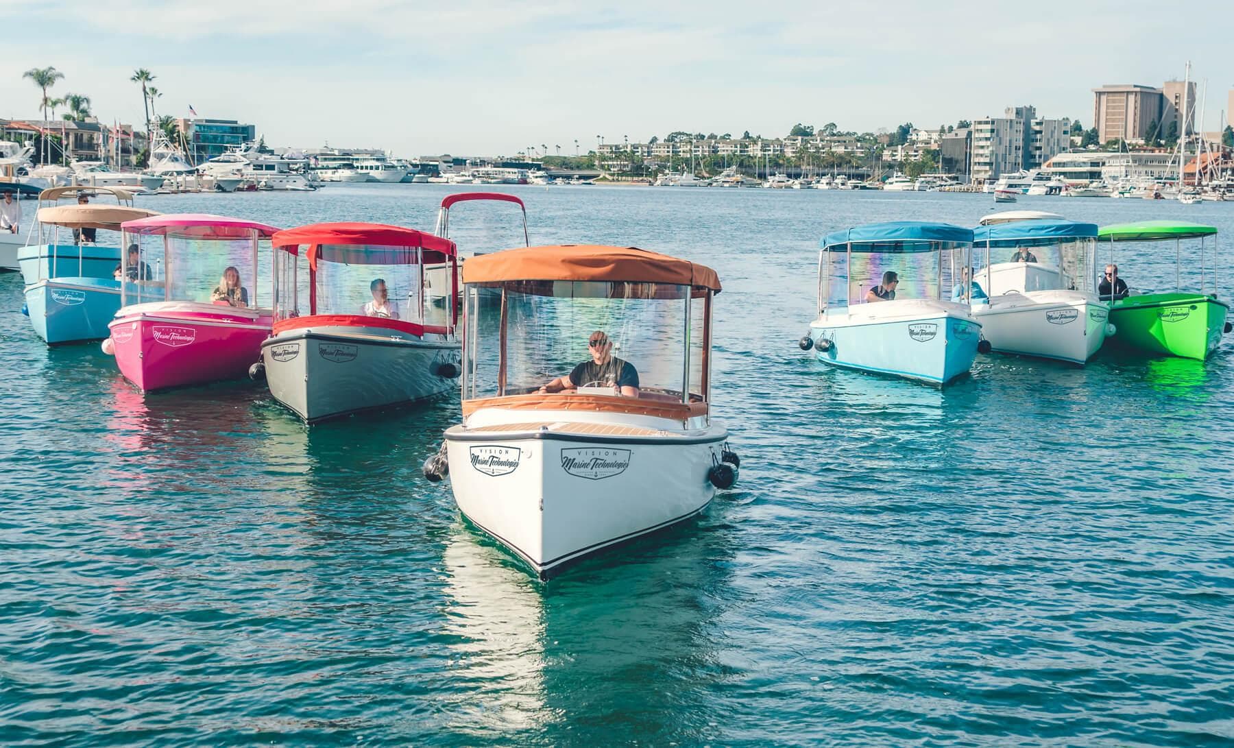 Colorful 2024 Vision Marine Technologies Fantail 217 boats on water, showcasing modern design.