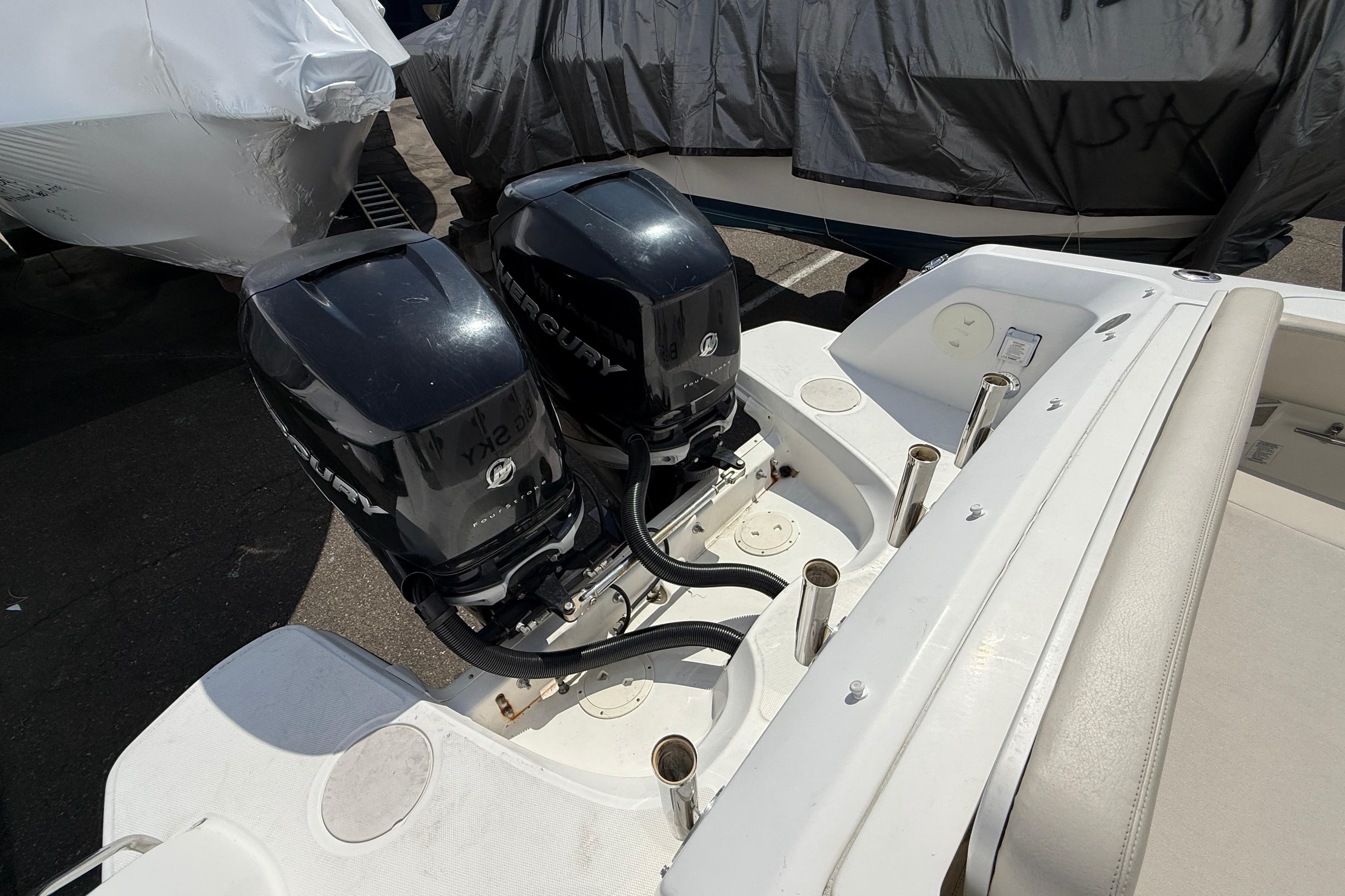 2016 Boston Whaler 270 Vantage with dual Mercury outboard engines, docked and covered.