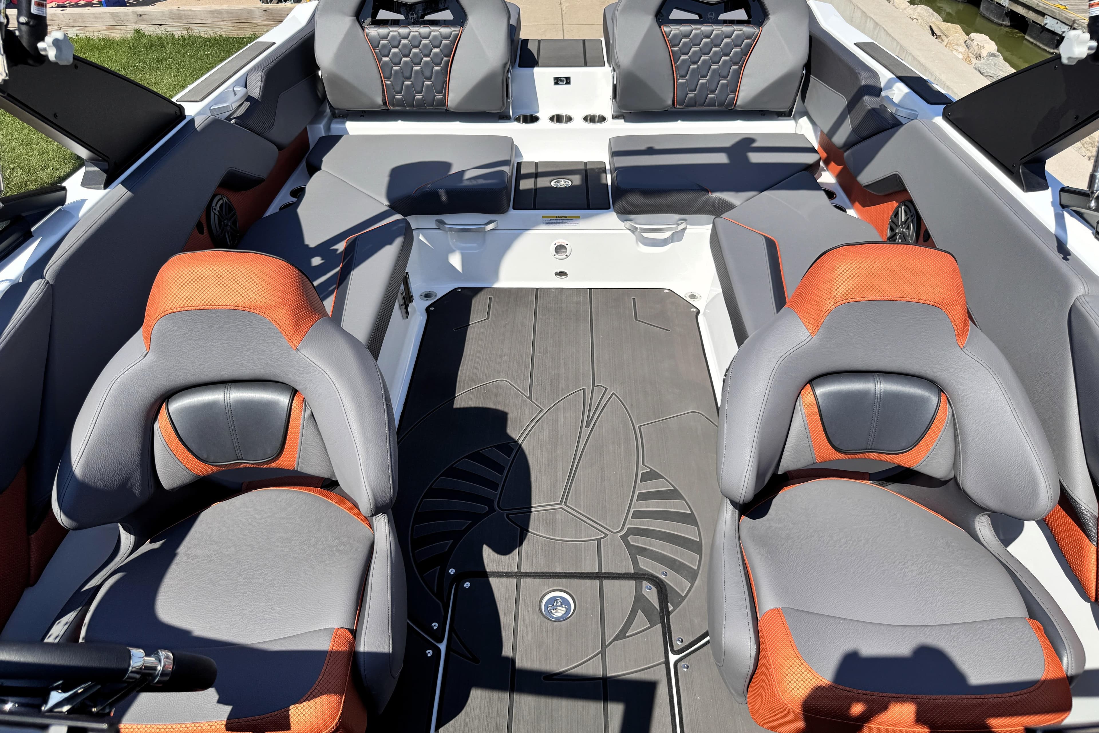 2026 Scarab 235 LX Wake boat interior with gray and orange seating, modern design.