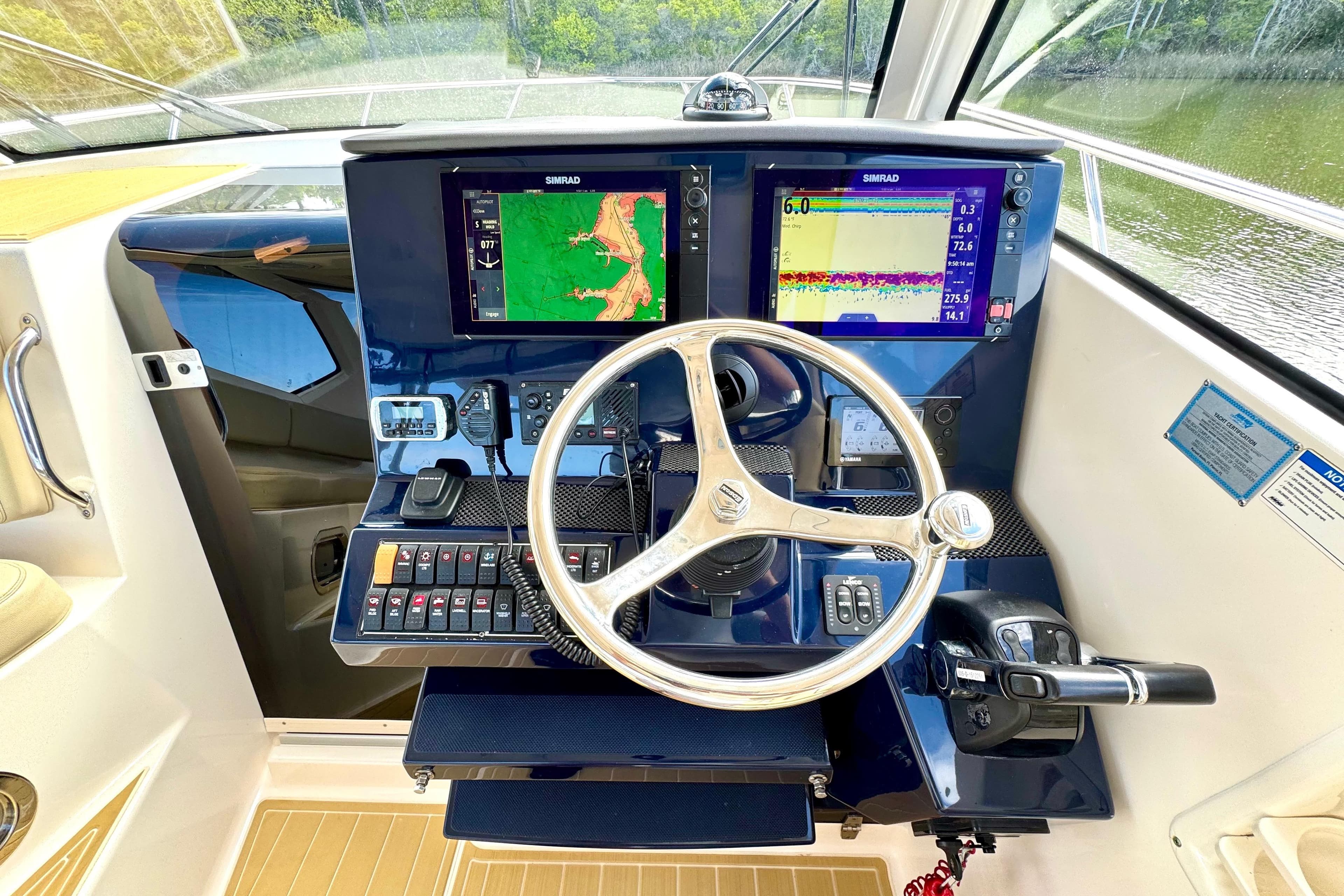 Helm of 2016 Pursuit OS 325 Offshore boat with dual Simrad displays and controls.
