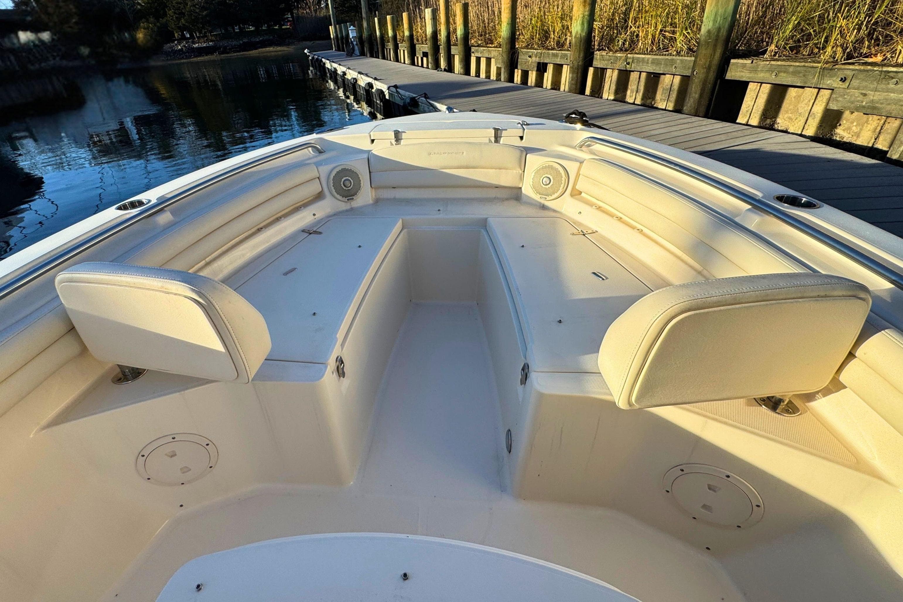 2018 Grady-White Fisherman 216 boat interior with cushioned seating and speakers at dock.