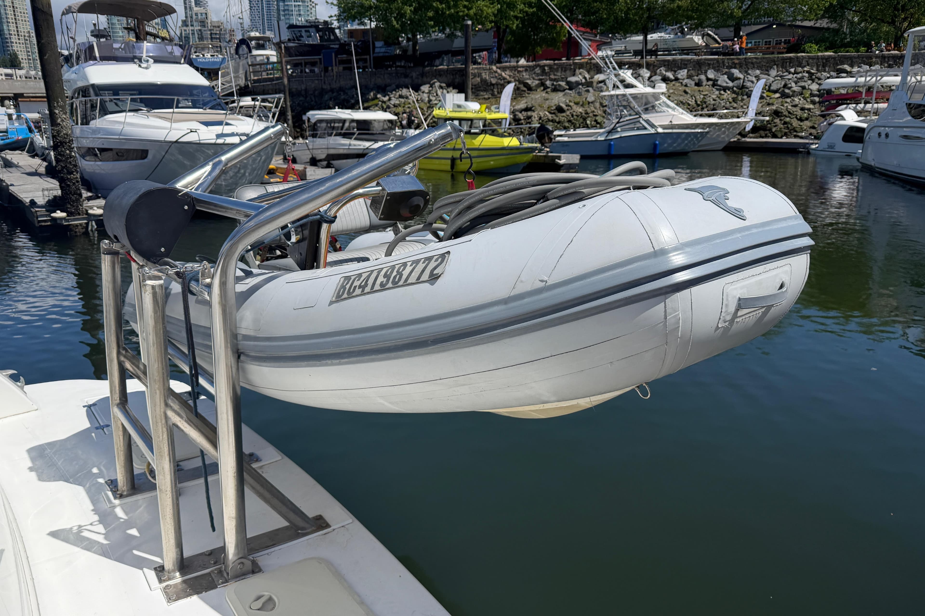 2001 Cruisers Yachts 5000 Sedan Sport with dinghy at marina dock.
