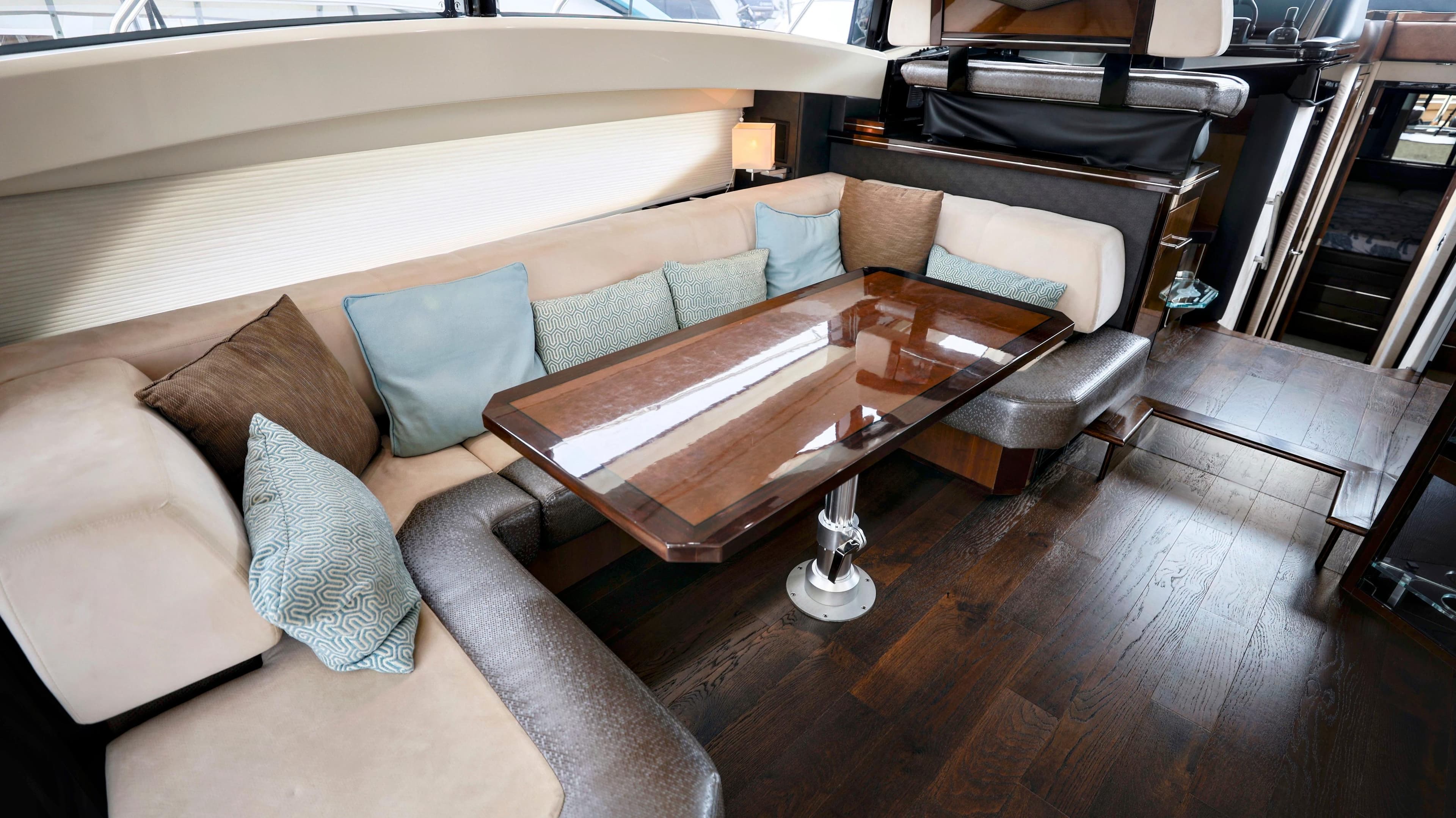 Luxurious interior of 2013 Marquis 500 Sport Bridge yacht with elegant seating and table.