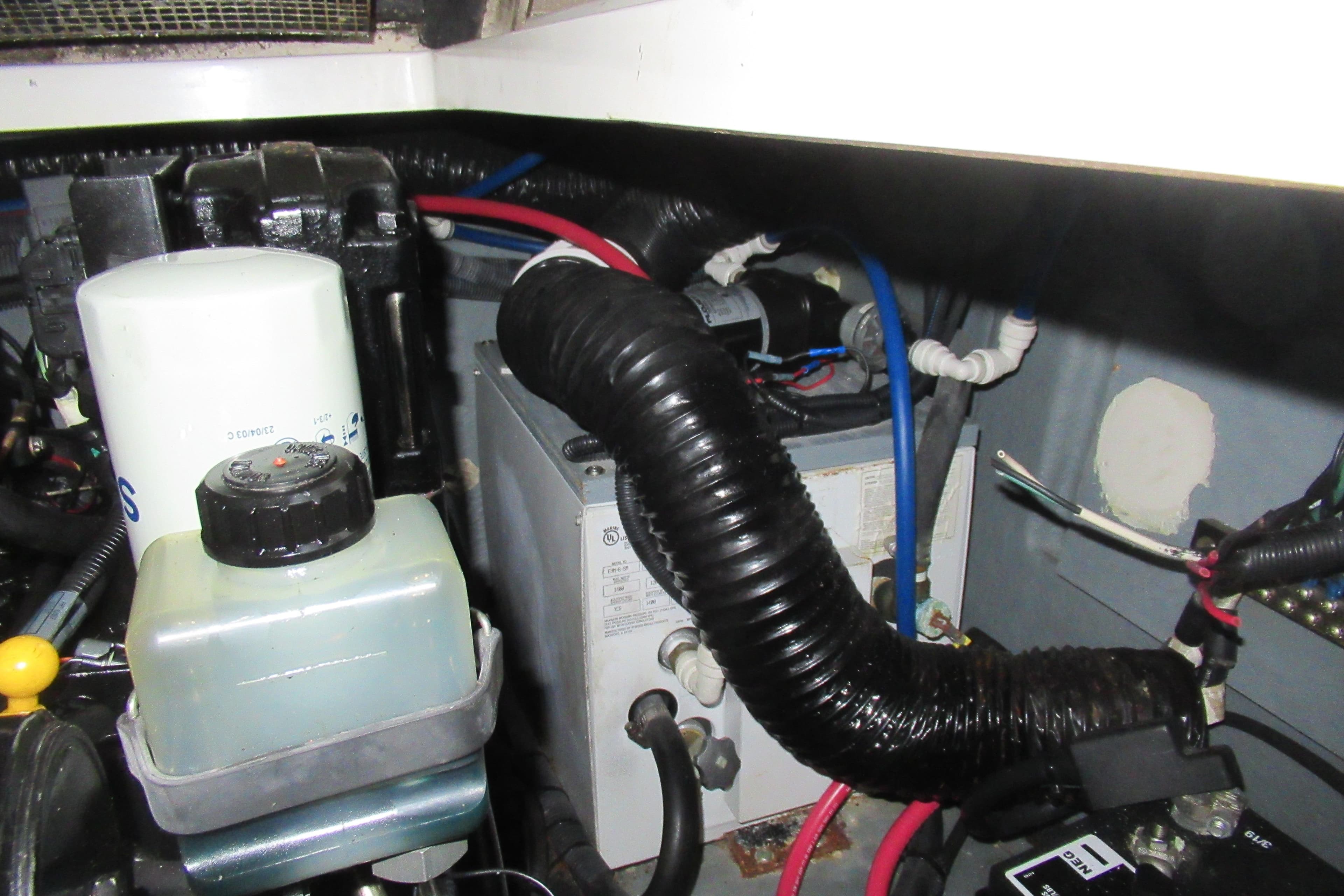 Engine compartment of 2001 Searay 280 Sundancer with hoses and components visible.