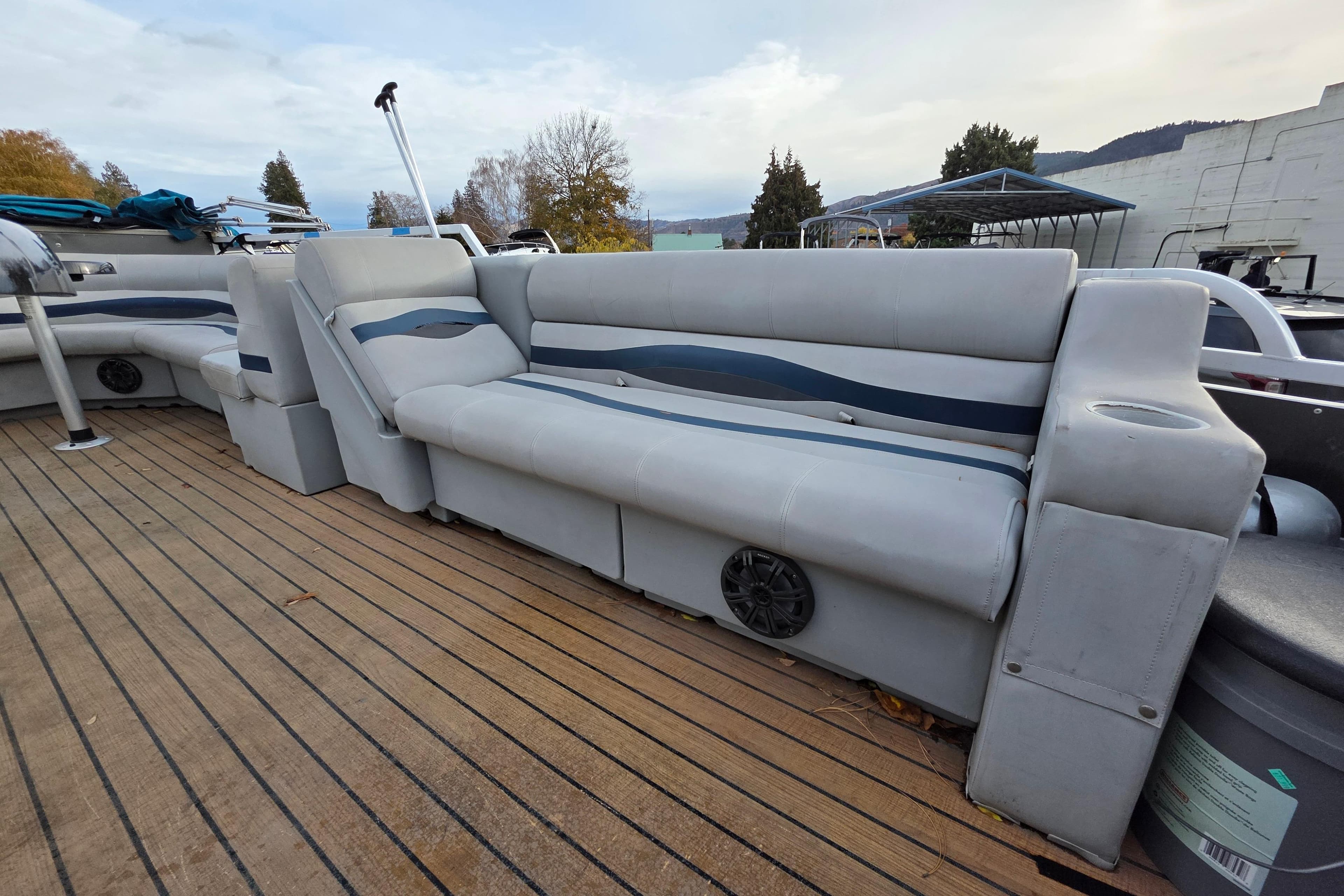 2001 J C Manufacturing TRITOON 226 I/O boat with spacious seating on wooden deck.
