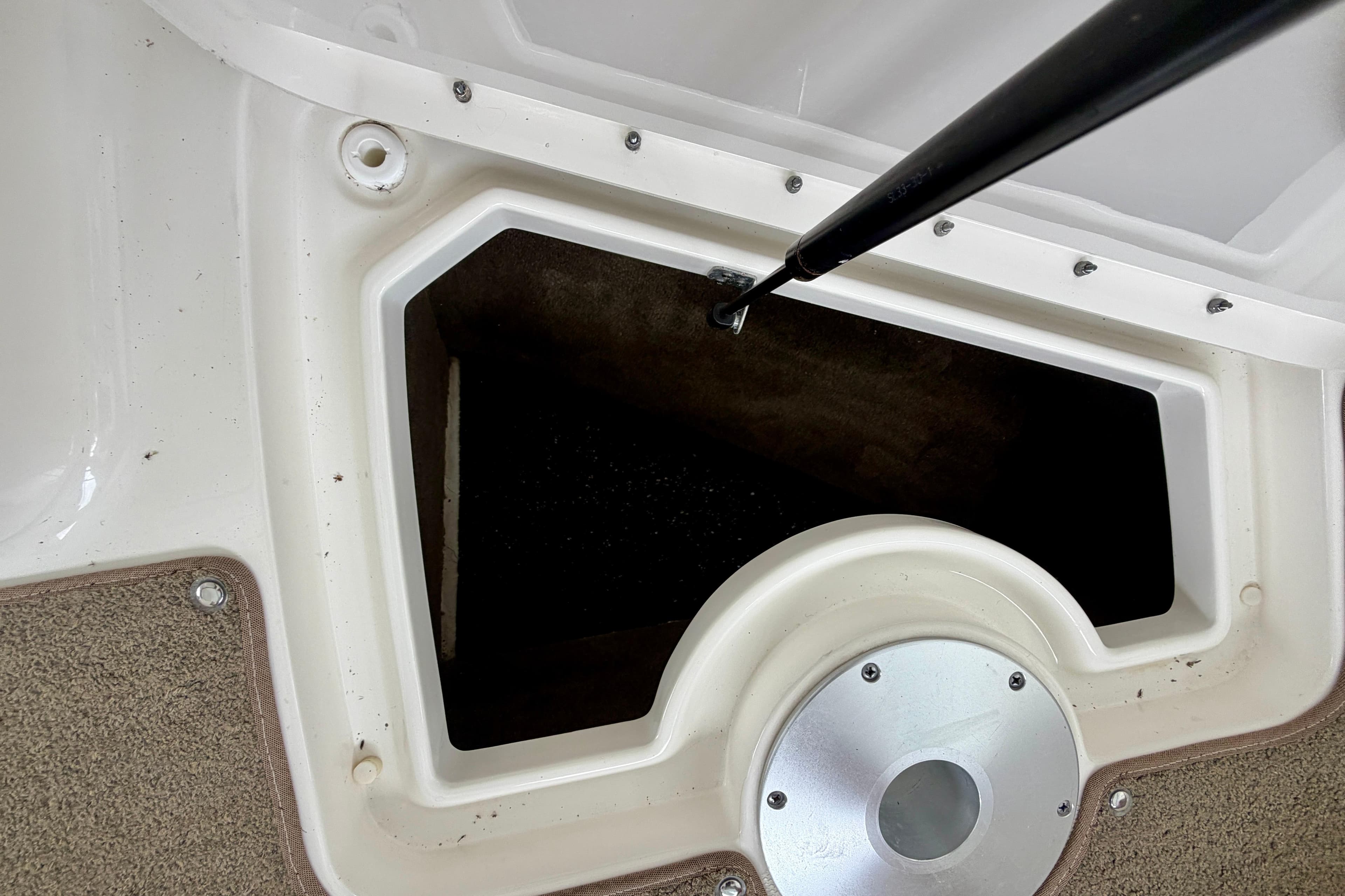 Storage compartment on a 2015 Sea Ray SLX 350 boat, featuring a hydraulic lift.
