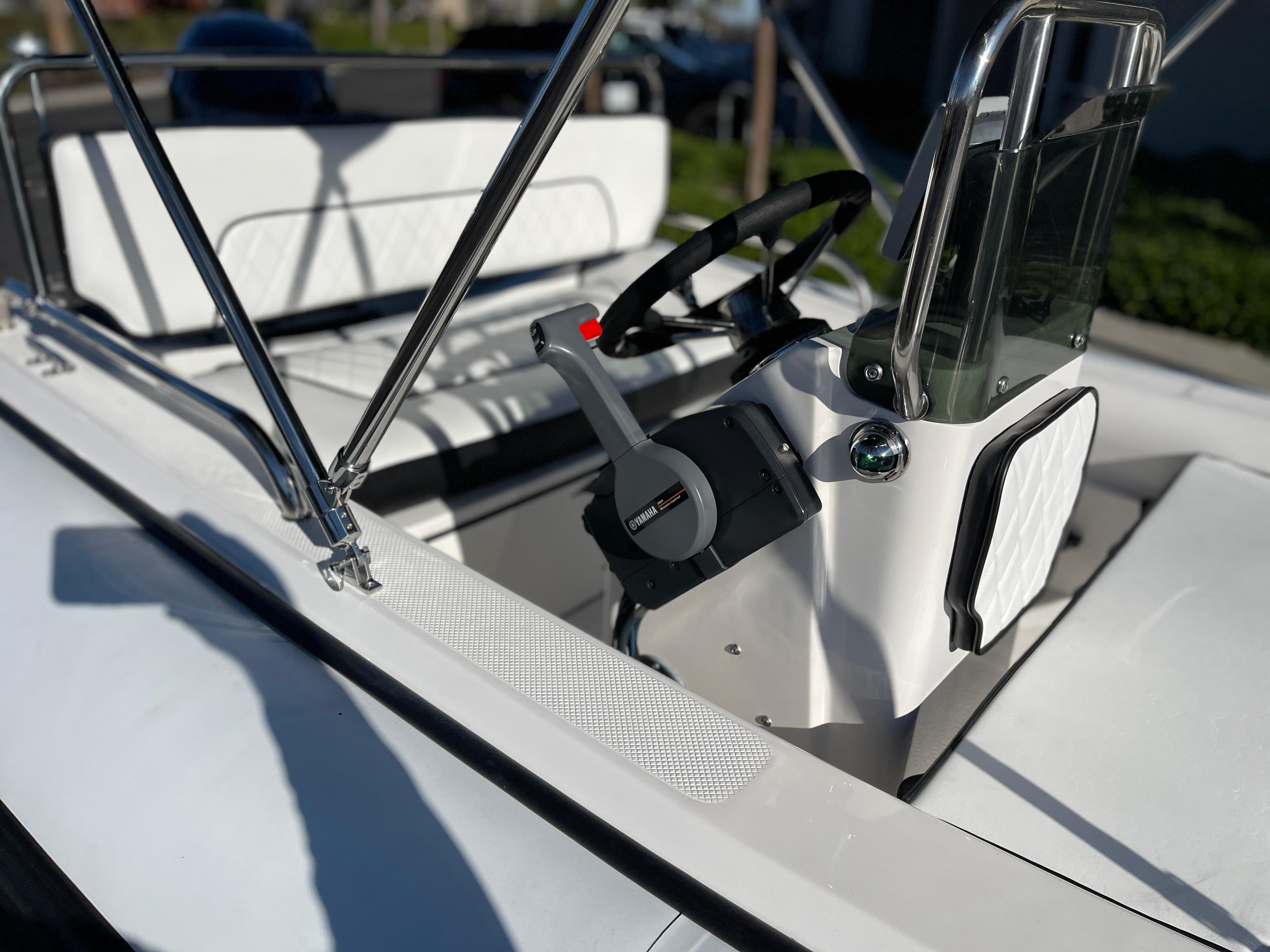 1998 Rendova 14 boat interior with steering wheel and seating.