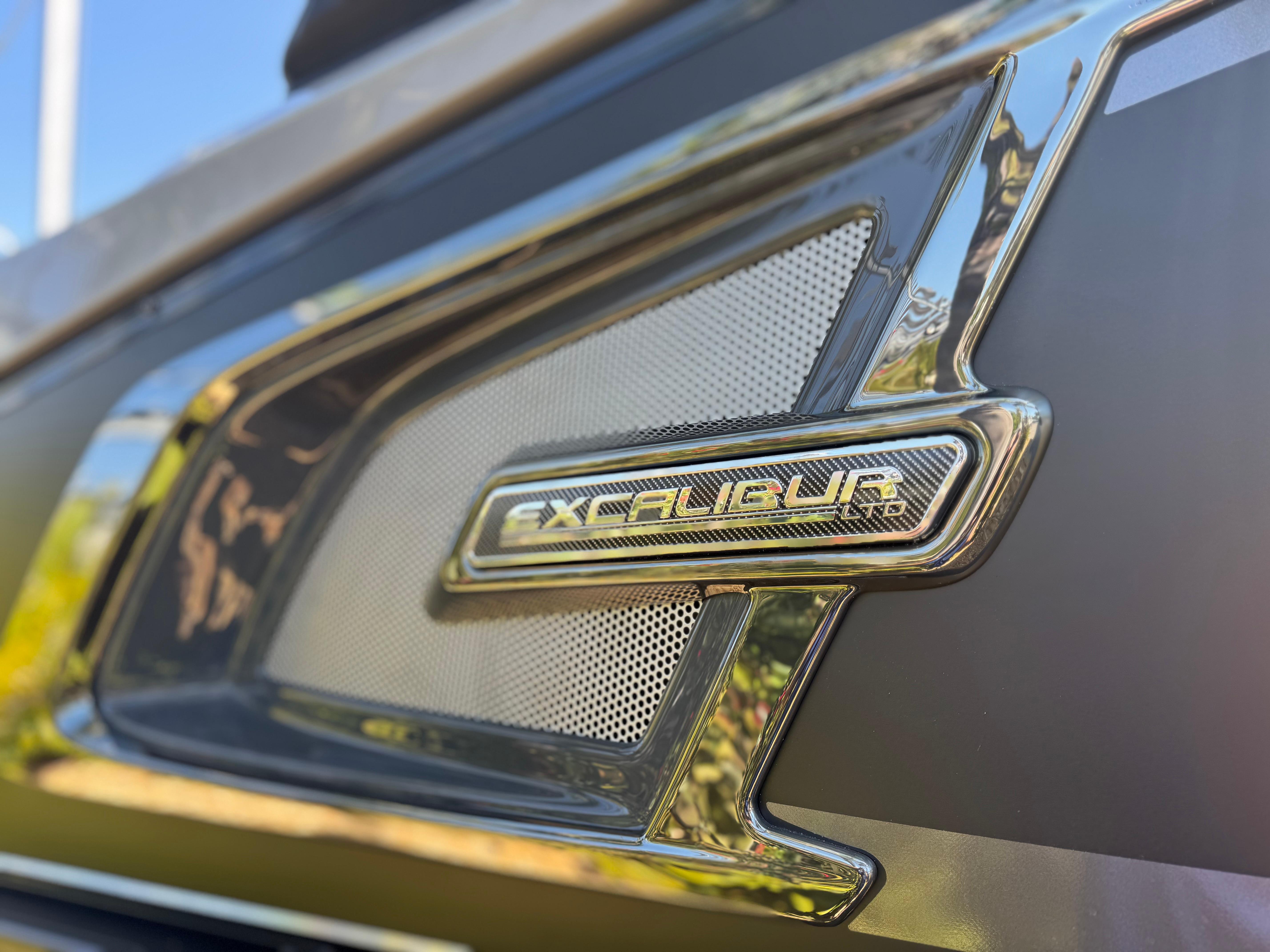 2025 Avalon Excalibur 27' emblem close-up with sleek metallic design.