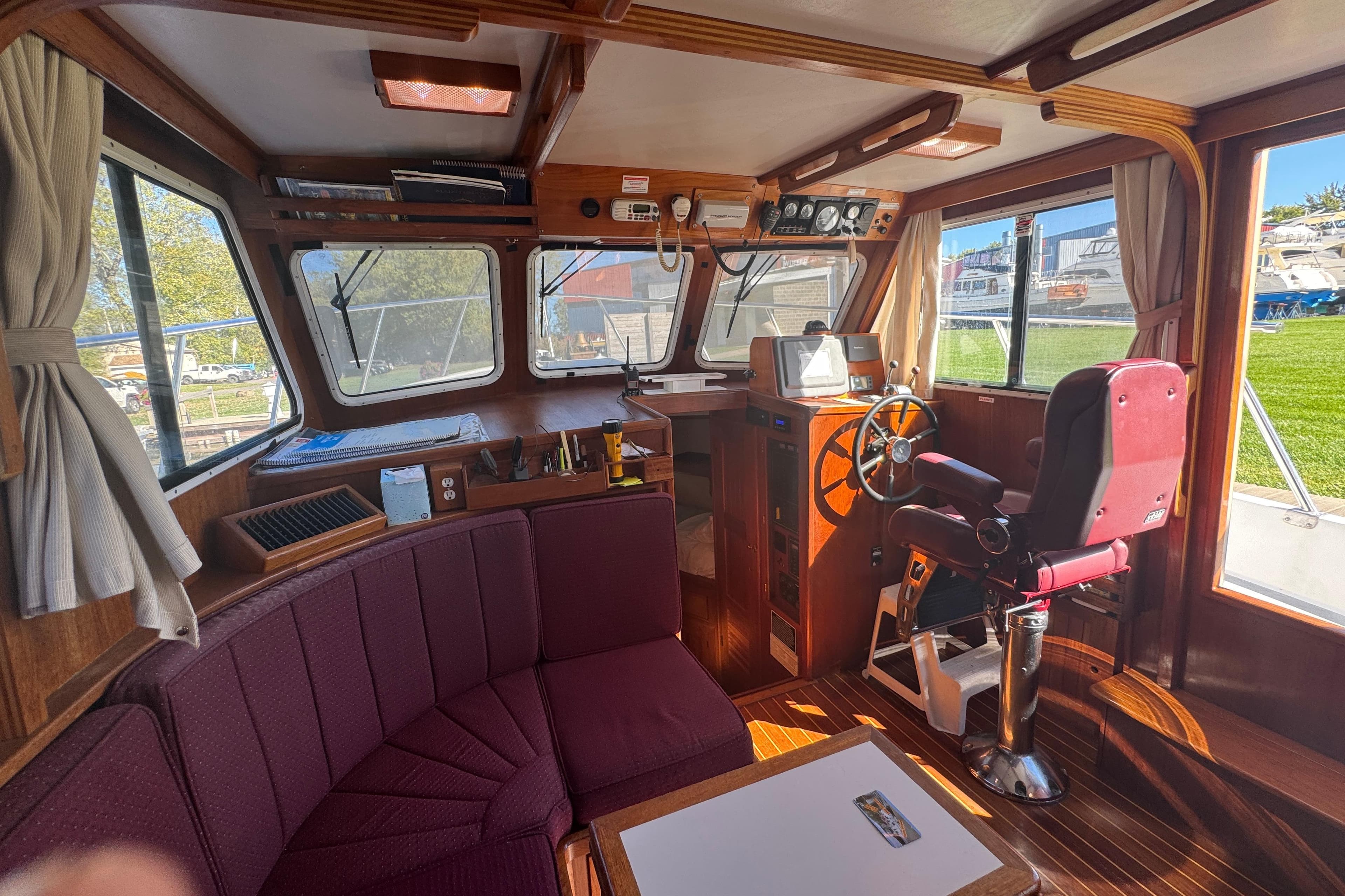 Interior of a 2001 Monk Trawler with helm, seating, and navigation equipment.