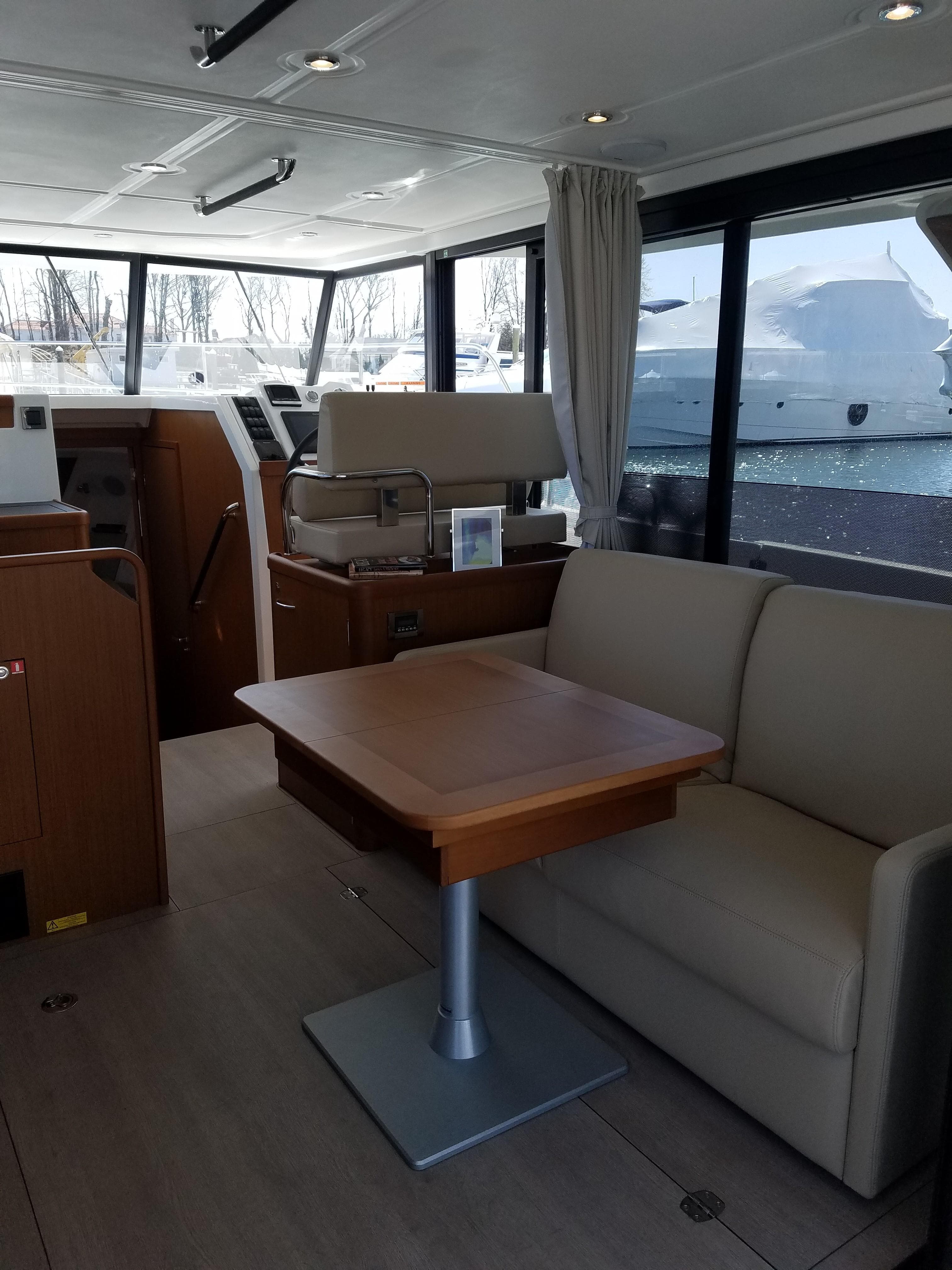 Interior of 2019 Beneteau Swift Trawler 35 with sofa and table.
