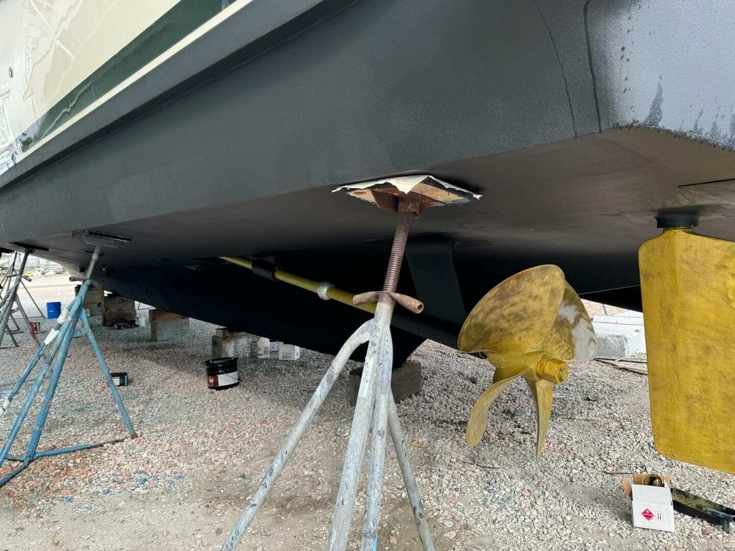 1985 Hatteras Enclosed Bridge boat under maintenance, showing propeller and hull details.