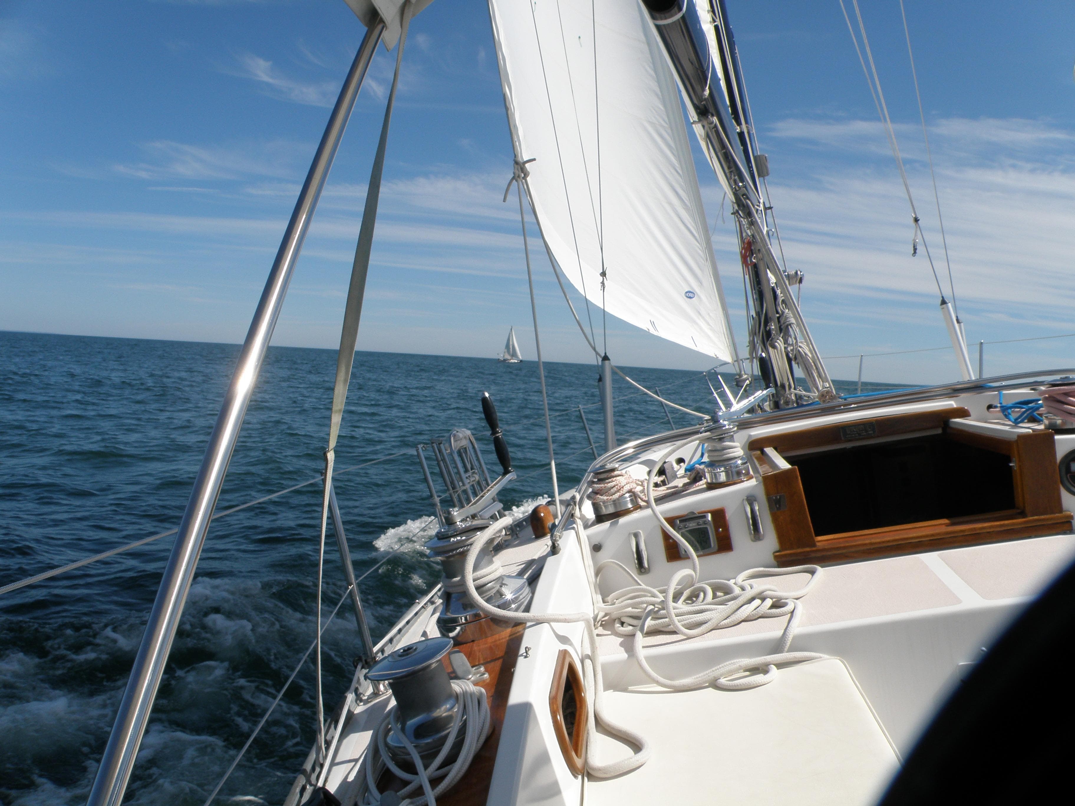 1972 Tartan 41 sailboat navigating open sea under clear blue skies.