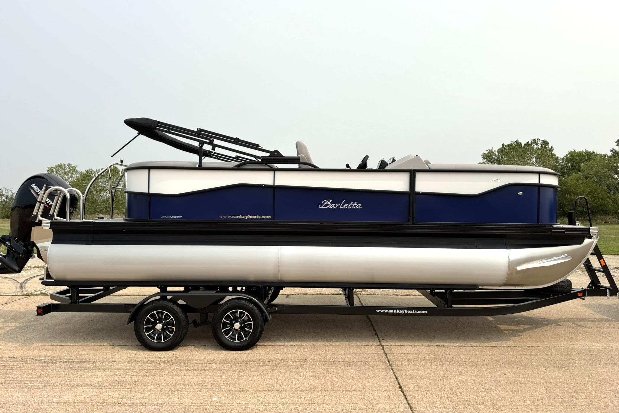 2026 Barletta ARIA 22QC pontoon boat on trailer, side view.