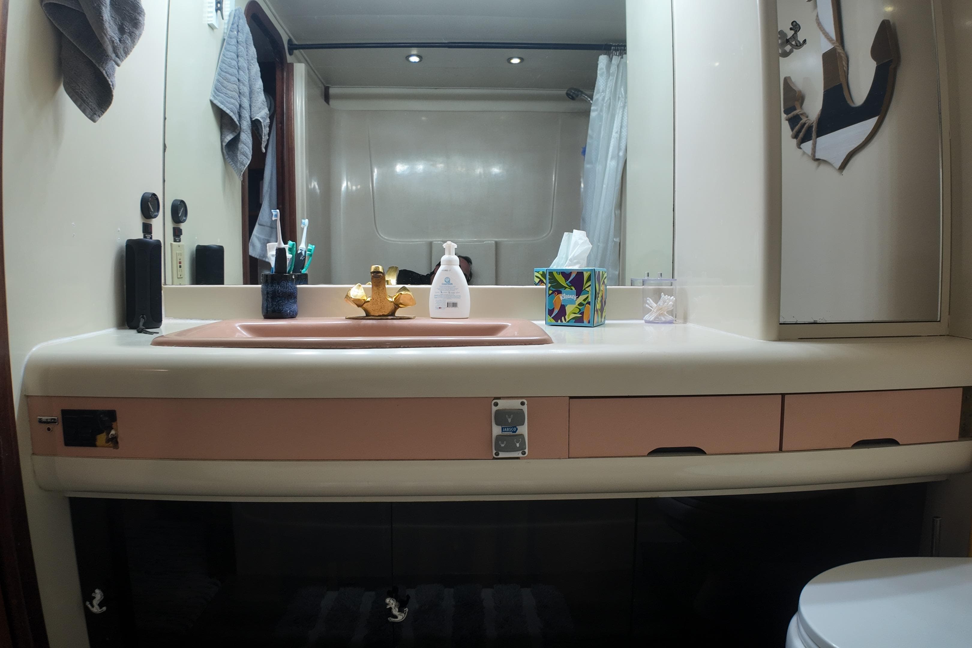 Bathroom interior of 1987 Viking Gulfstar yacht with sink, mirror, and toiletries.