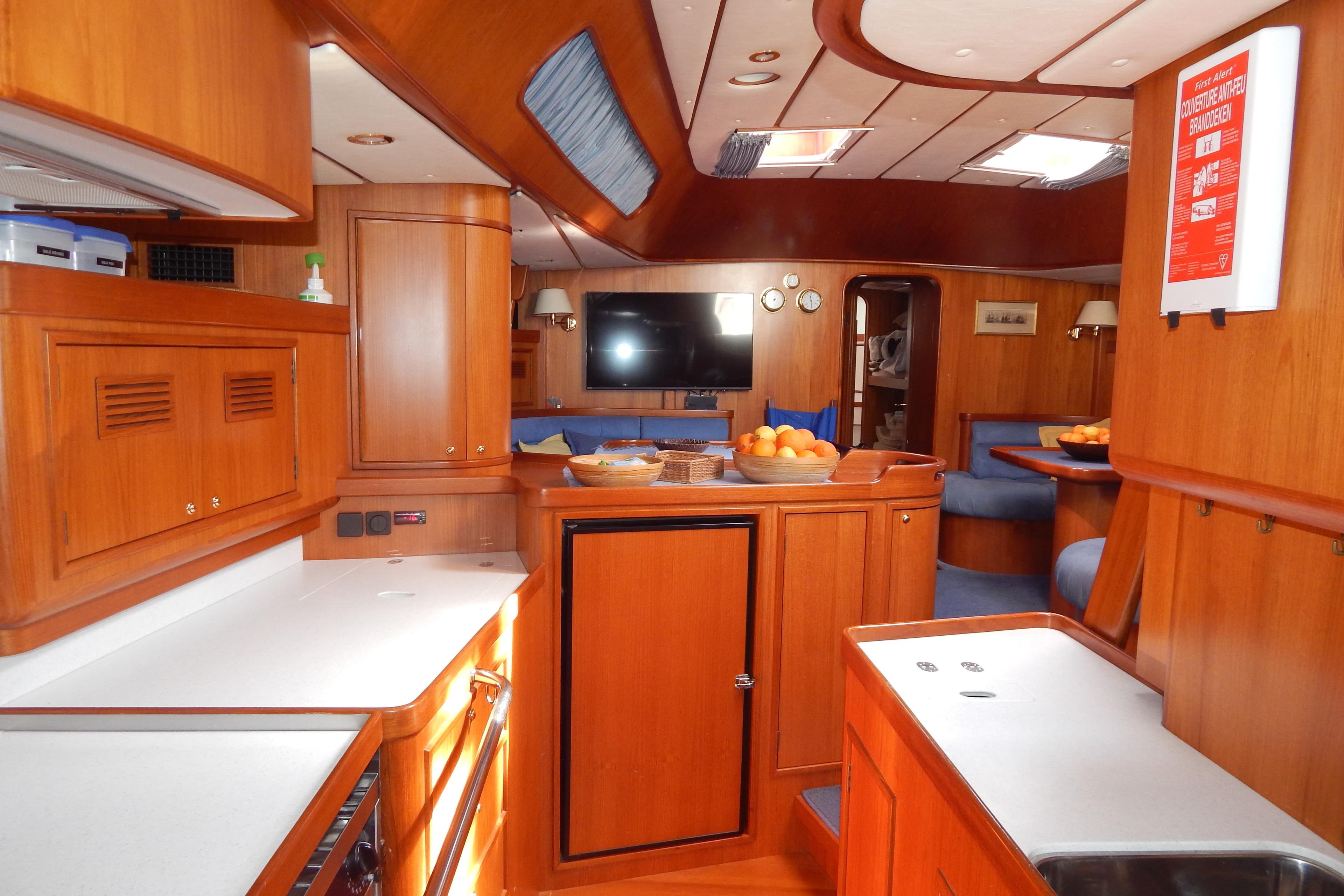 Luxurious 2003 Contest 60 C yacht interior with wooden cabinetry and modern amenities.