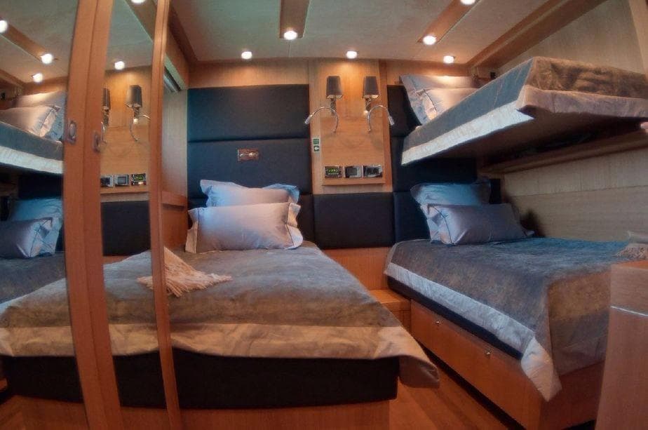 Luxurious bedroom in a 2011 Sunseeker 34 Metre Yacht with modern lighting and cozy beds.