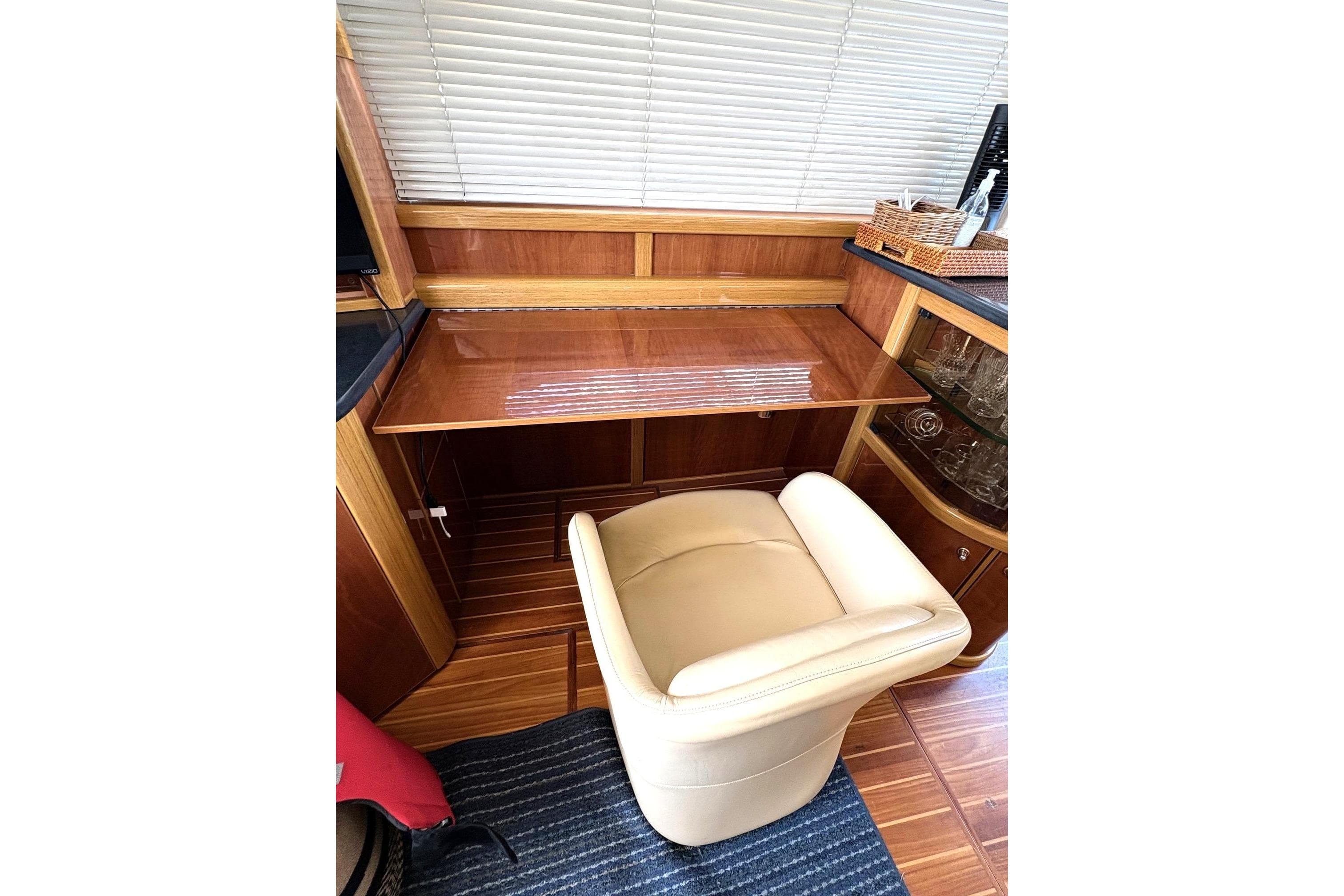 Luxurious interior of 2003 Sealine F42/5 yacht with elegant wood and leather furnishings.