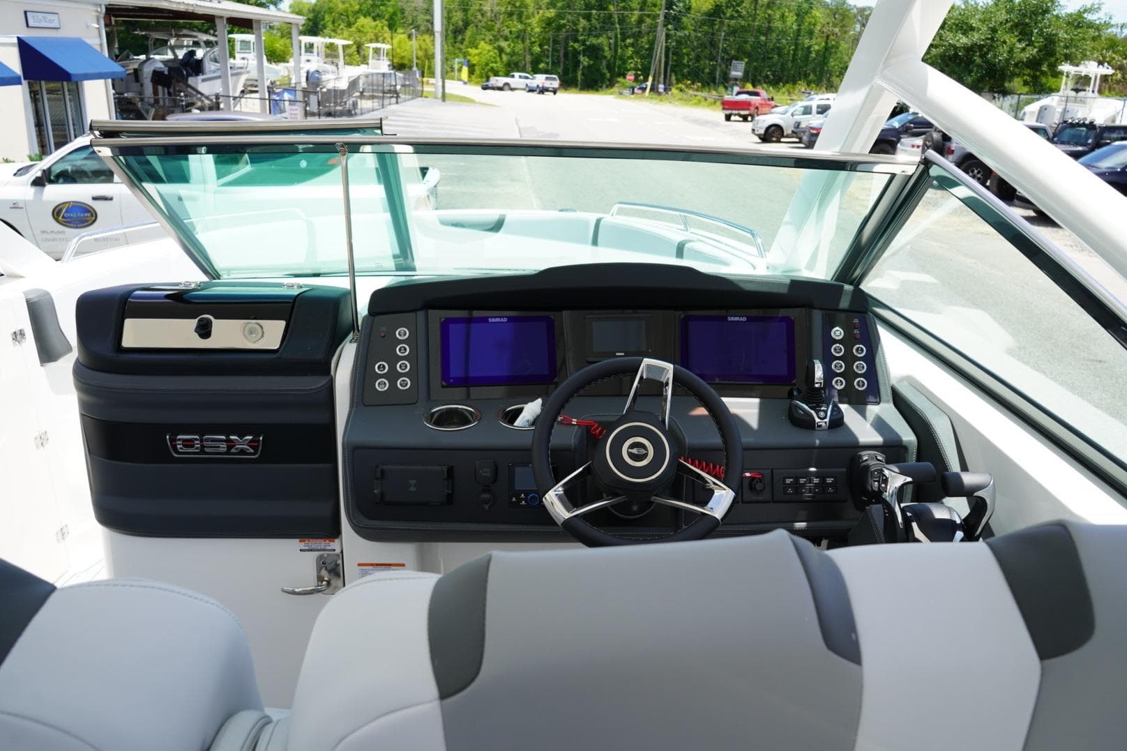2026 Chaparral 280 OSX boat dashboard with modern controls and steering wheel.