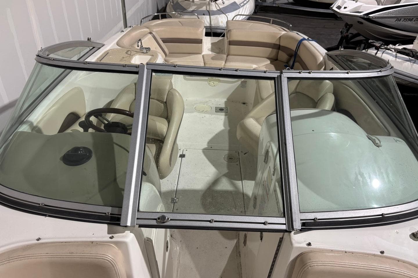 2008 Chaparral 246 SSi boat interior with beige seating and steering wheel.
