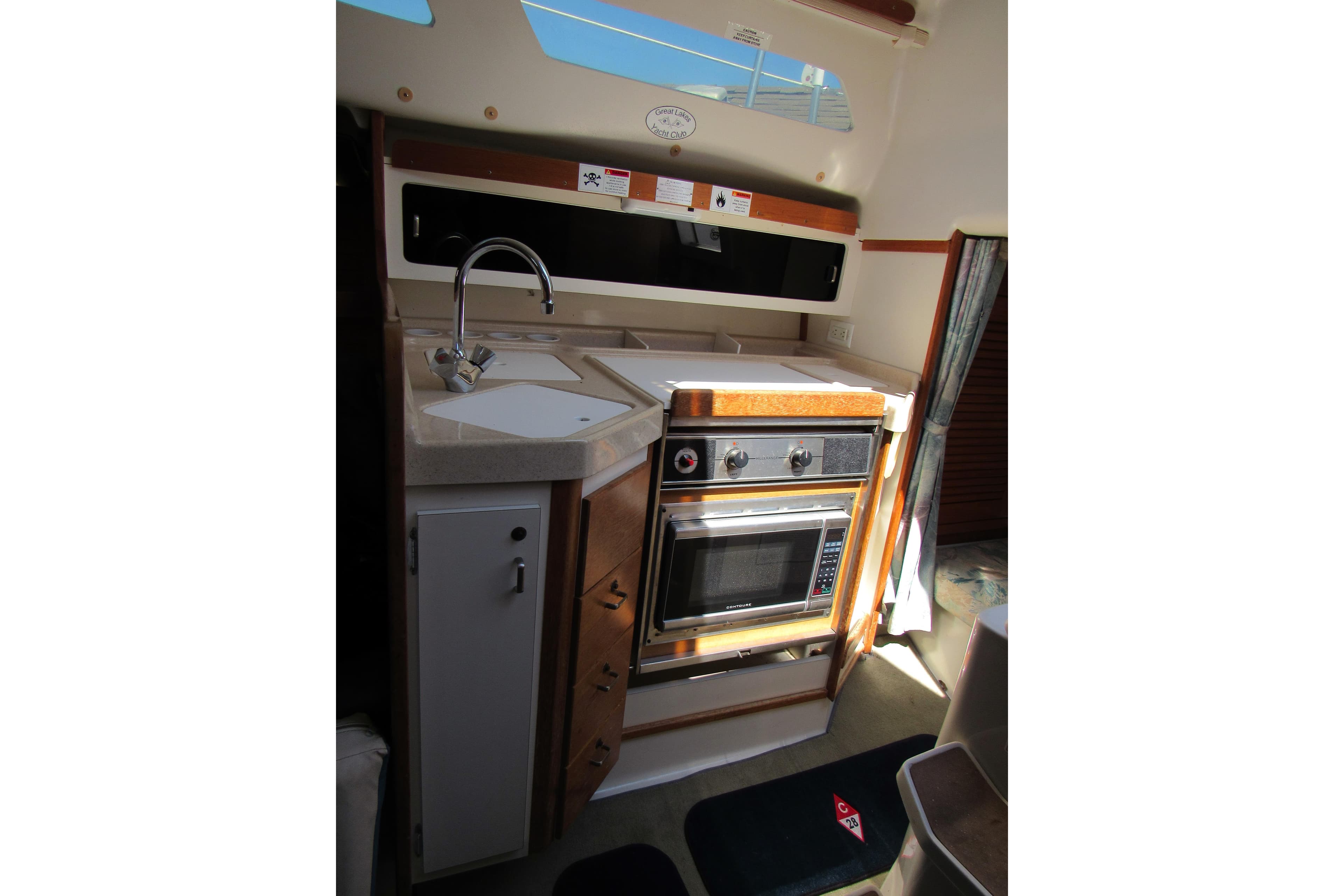 1997 Catalina 28 MkII yacht kitchen with sink, stove, and oven.