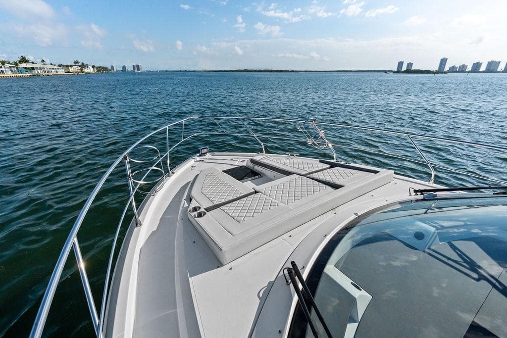 2023 Cruisers 42 Cantius yacht on open water, featuring spacious deck and scenic view.