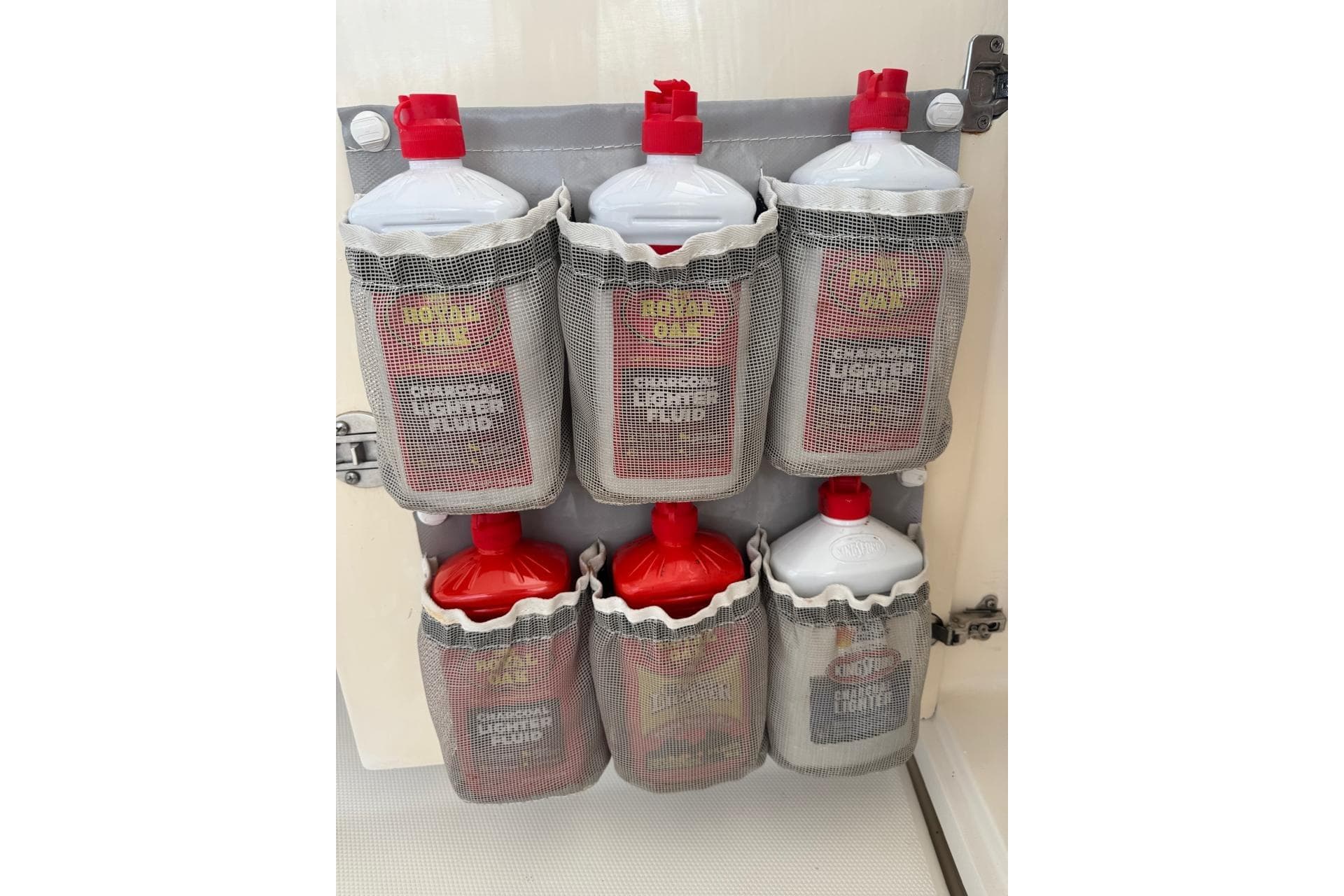 Storage rack with charcoal lighter fluid bottles on a Leopard 45, 2017 model.