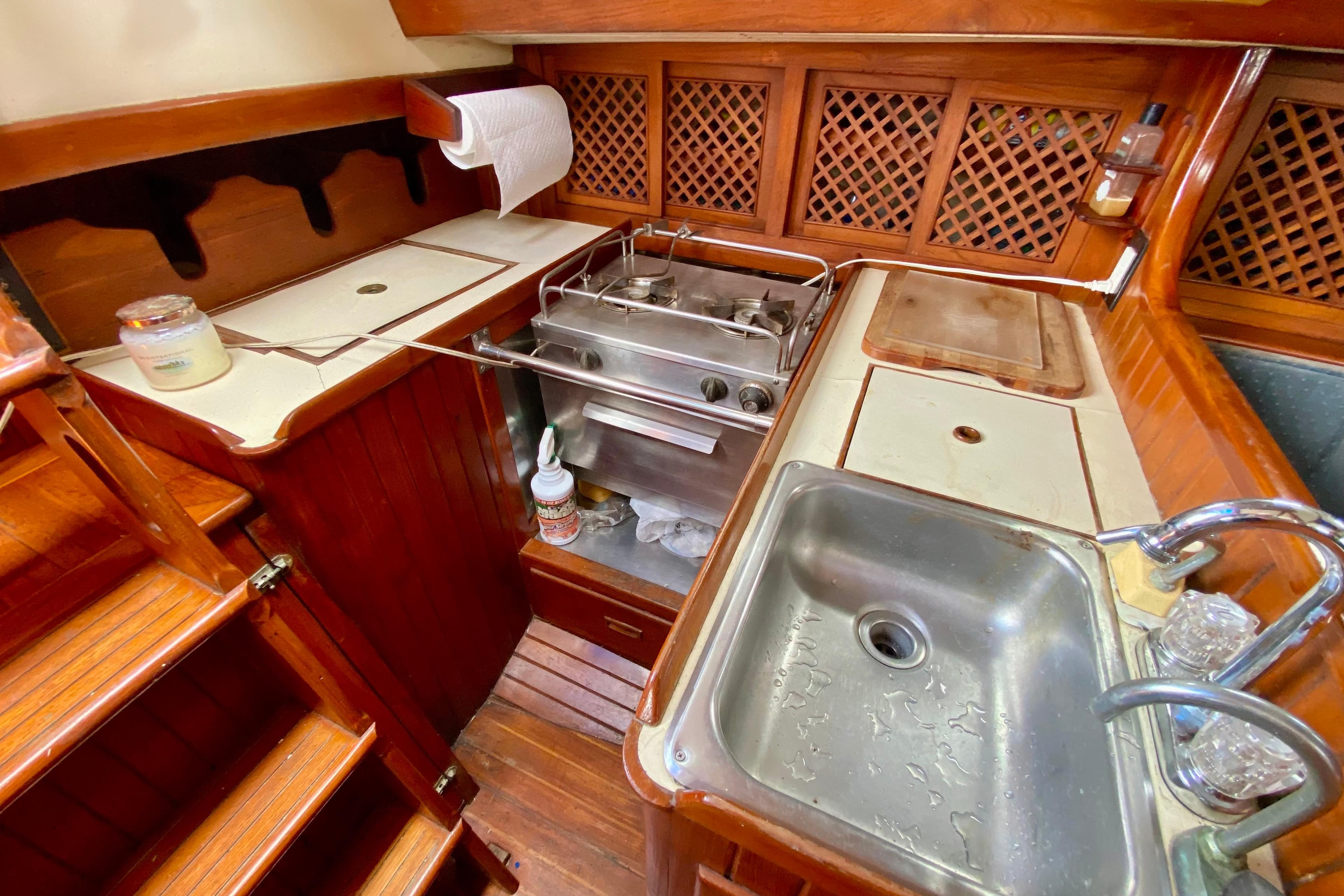 1981 Union EO 32 yacht galley with wooden cabinetry, sink, and stove.