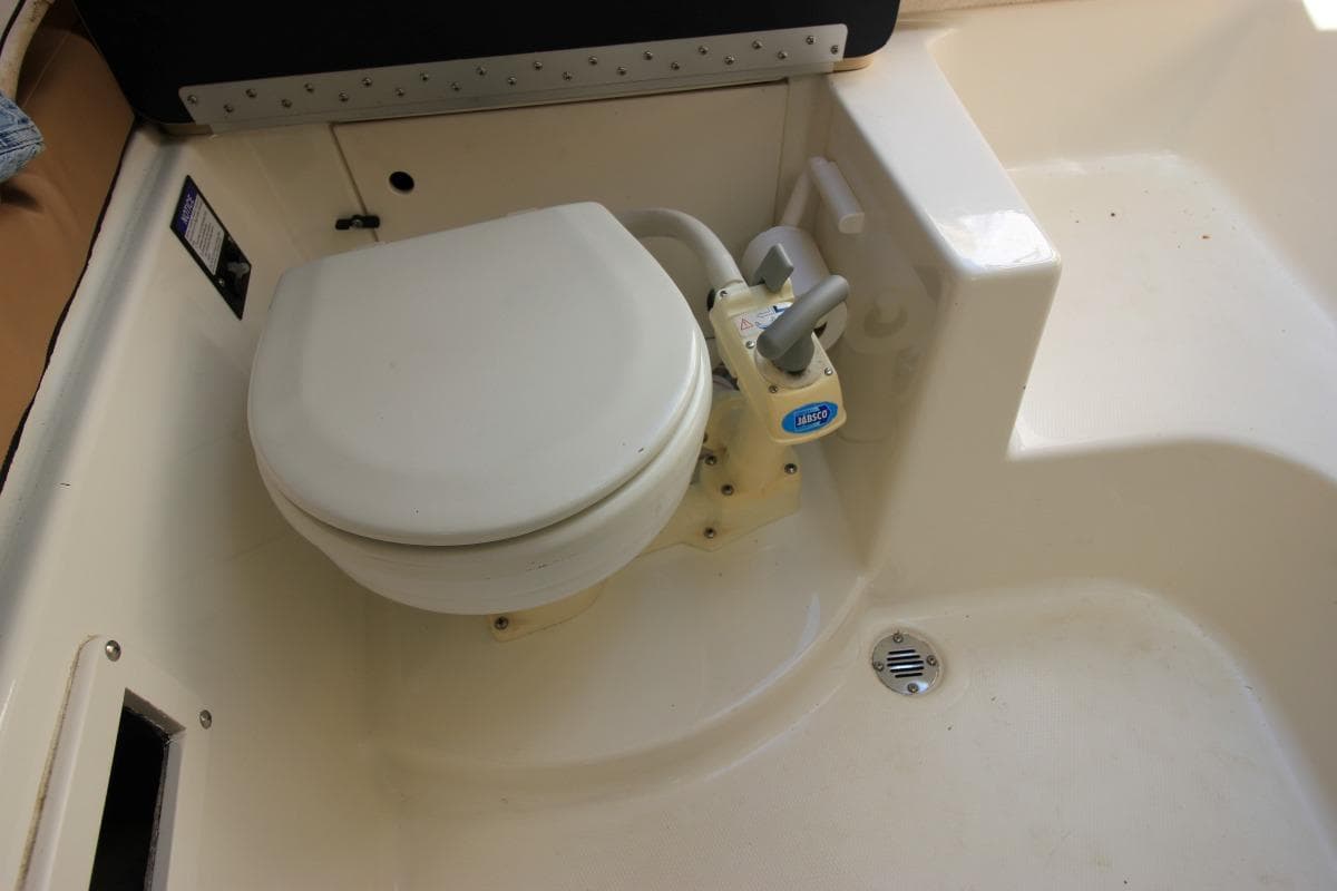 2008 Trophy 2302 Walkaround boat toilet with manual pump system.