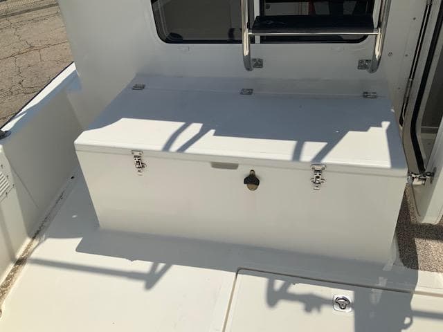 Nordic Tug 32 (2010) boat deck with storage compartment and metal railing.