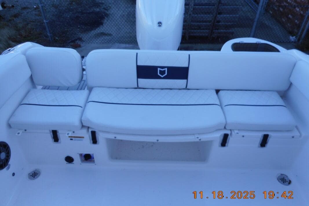 2026 Sea Fox 228 Traveler boat interior with white cushioned seating and storage compartments.