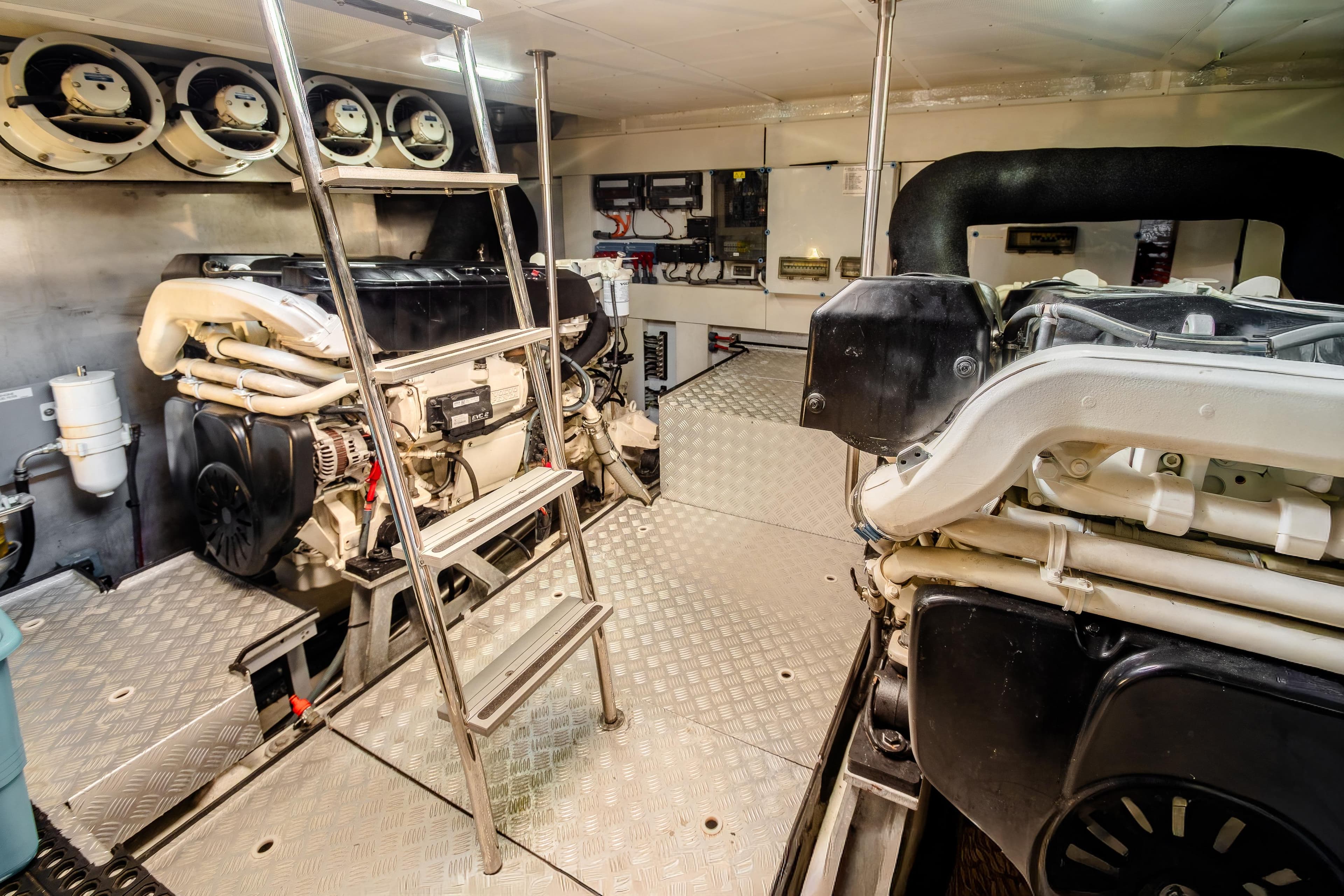 Engine room of 2023 Sirena 58 yacht with ladder and machinery.