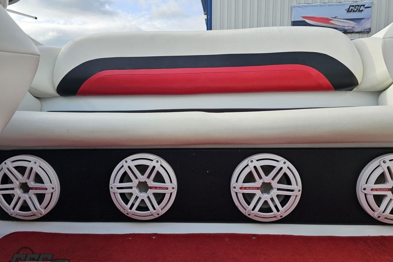 2004 Baja 275 boat interior with red and black seating, JL Audio speakers.