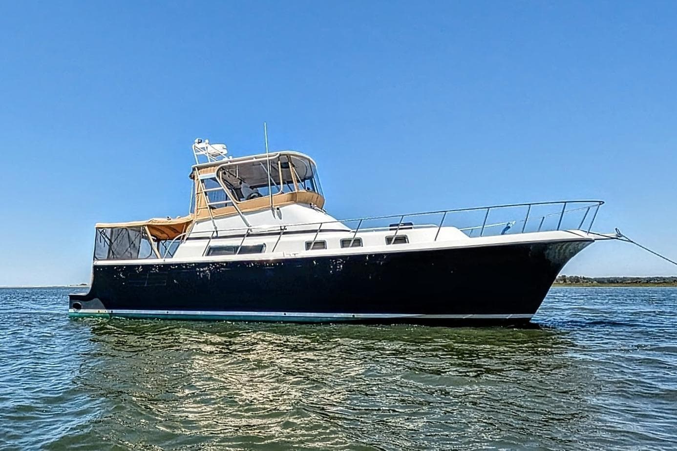 2007 Albin 45 Command Bridge yacht on calm water under clear blue sky.