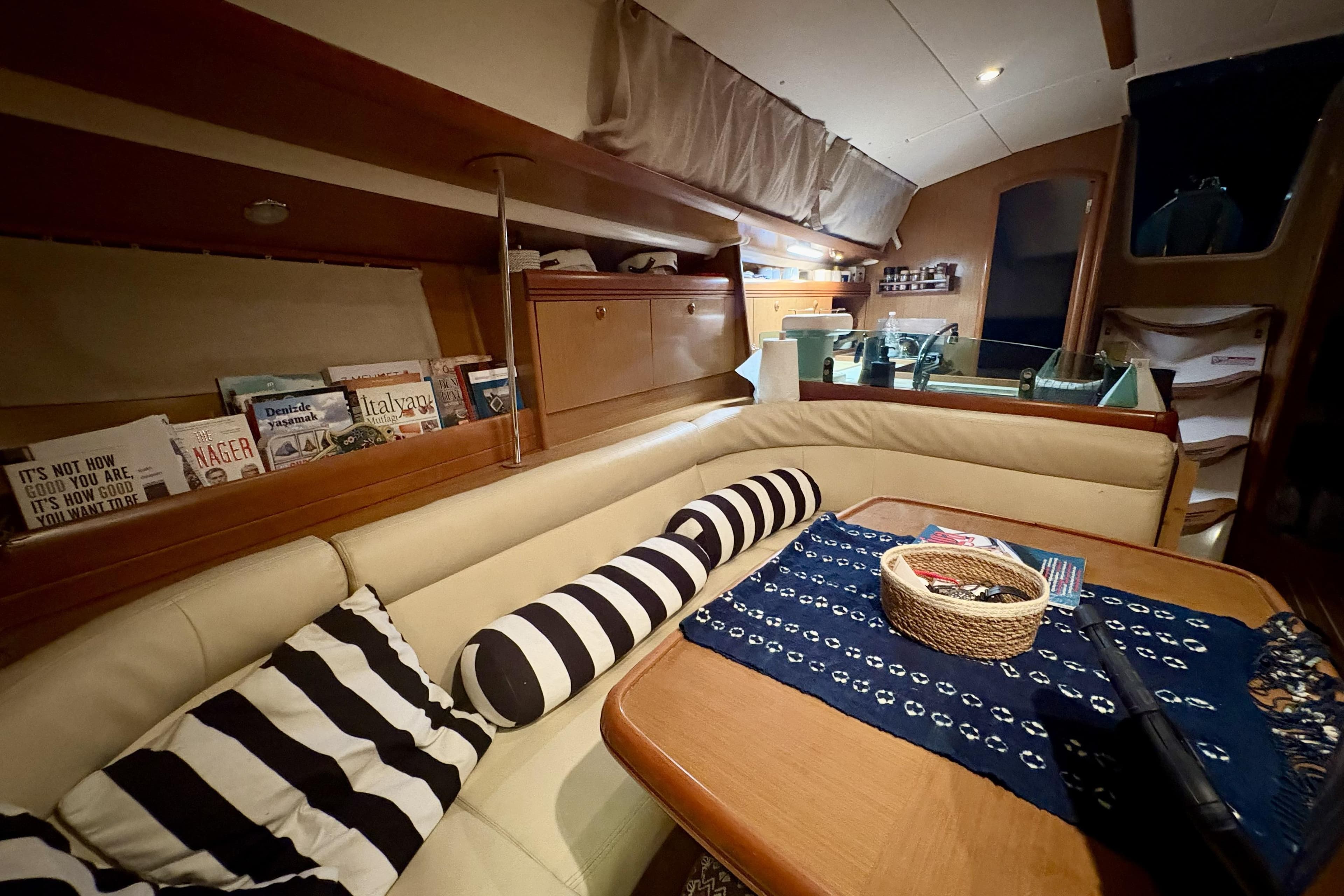 Interior of 2008 Jeanneau Sun Odyssey 39i yacht with cozy seating and nautical decor.