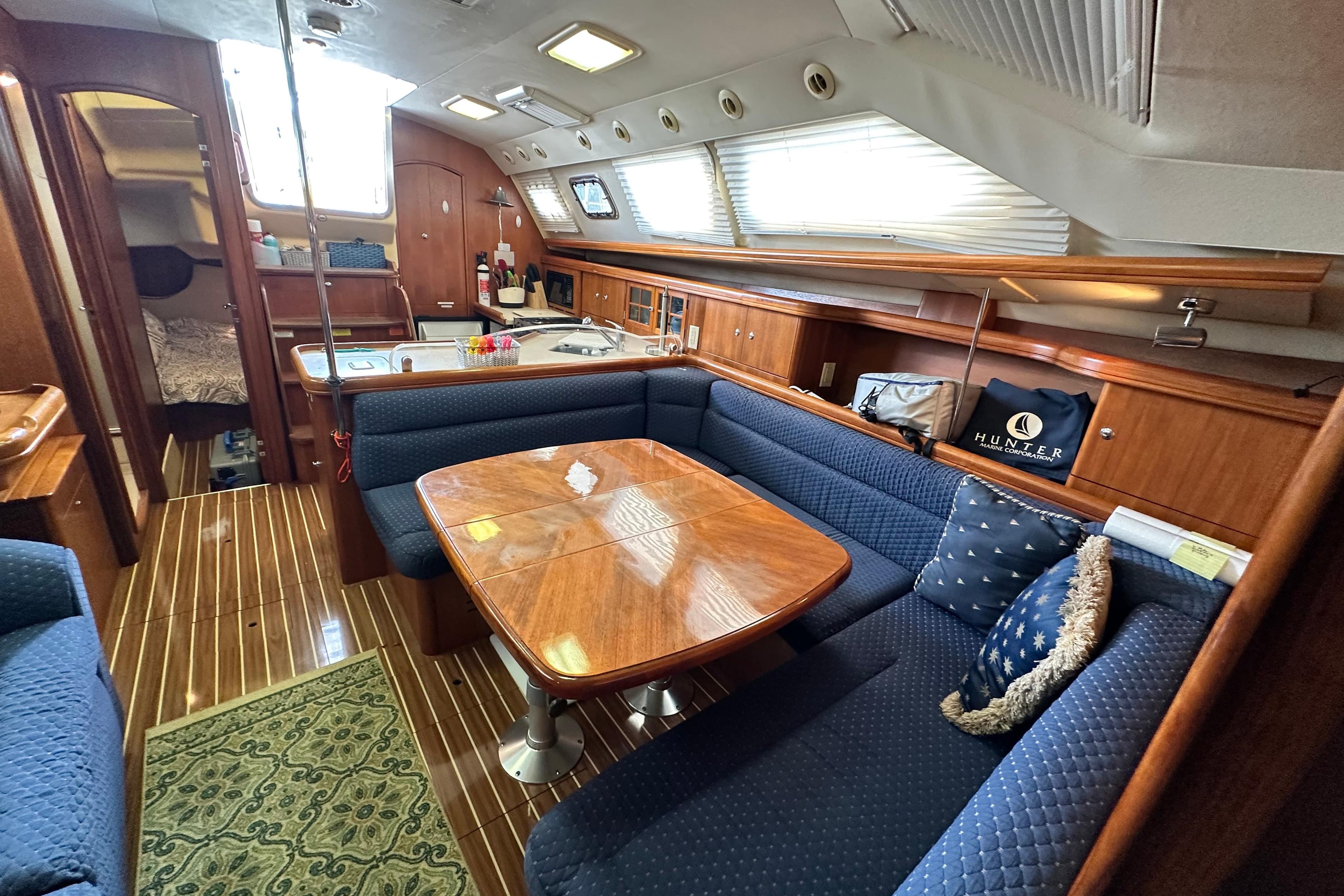 Interior of 2006 Hunter 41 Deck Salon with elegant wood finish and cozy seating.