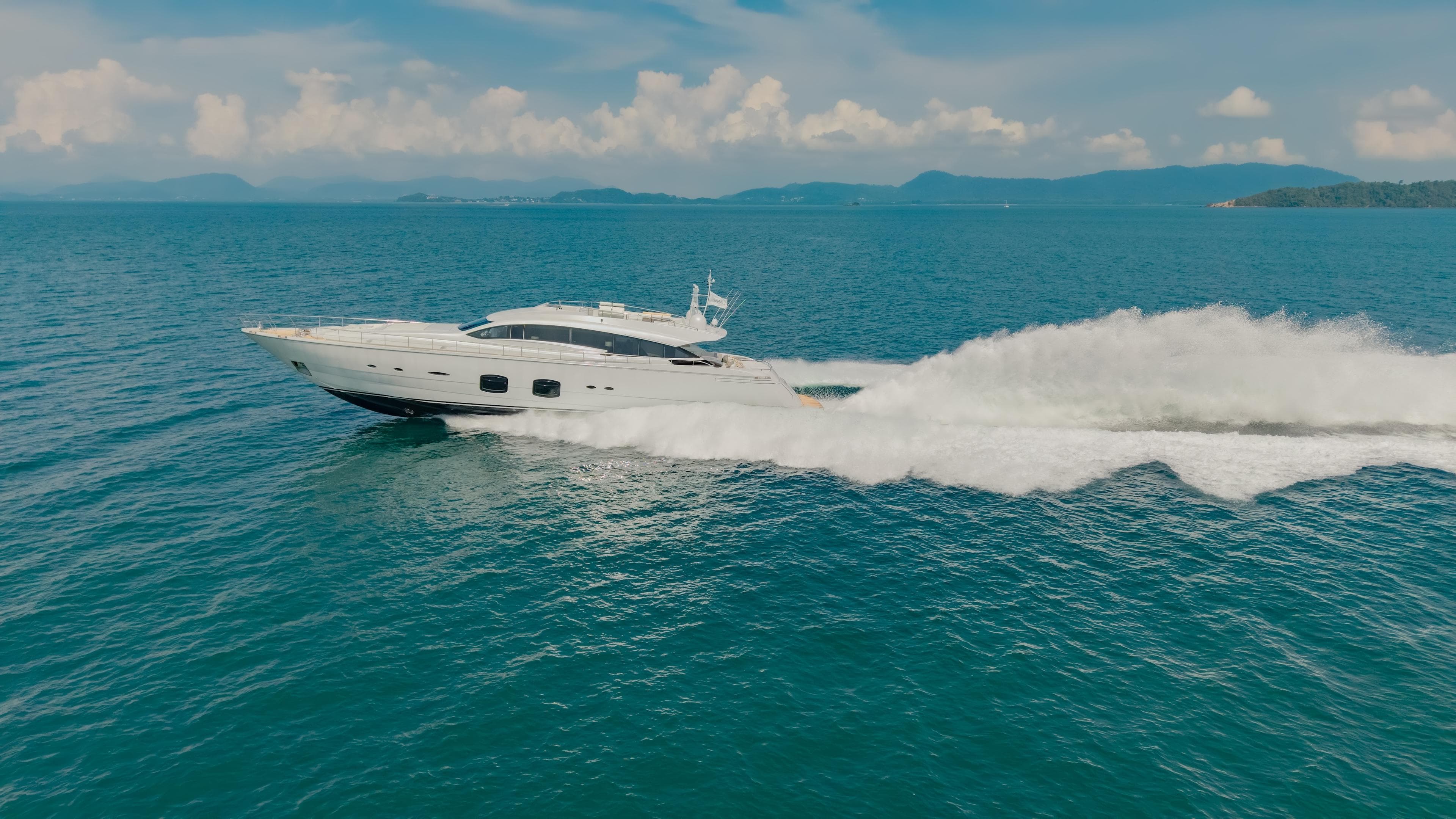 Luxurious 2011 Pershing 108 yacht cruising swiftly on open blue sea.
