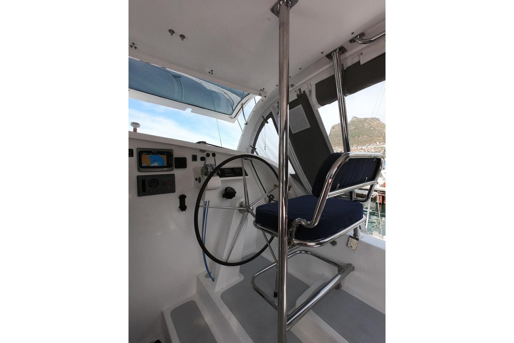 Helm station of 2006 Maxim Yachts 57, featuring steering wheel and navigation equipment.