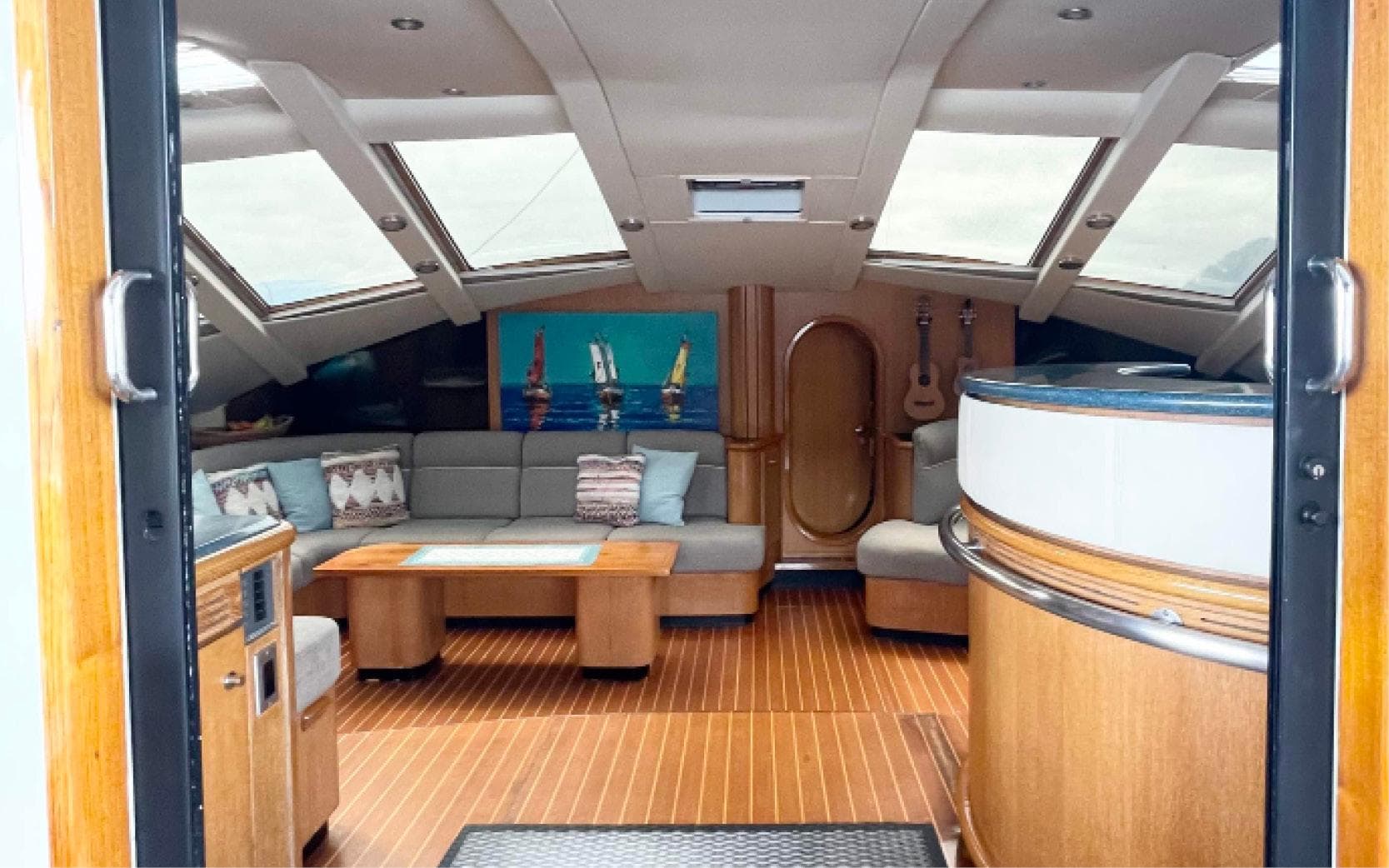Luxurious interior of 1996 Privilege 65 yacht with skylights and elegant wood finishes.