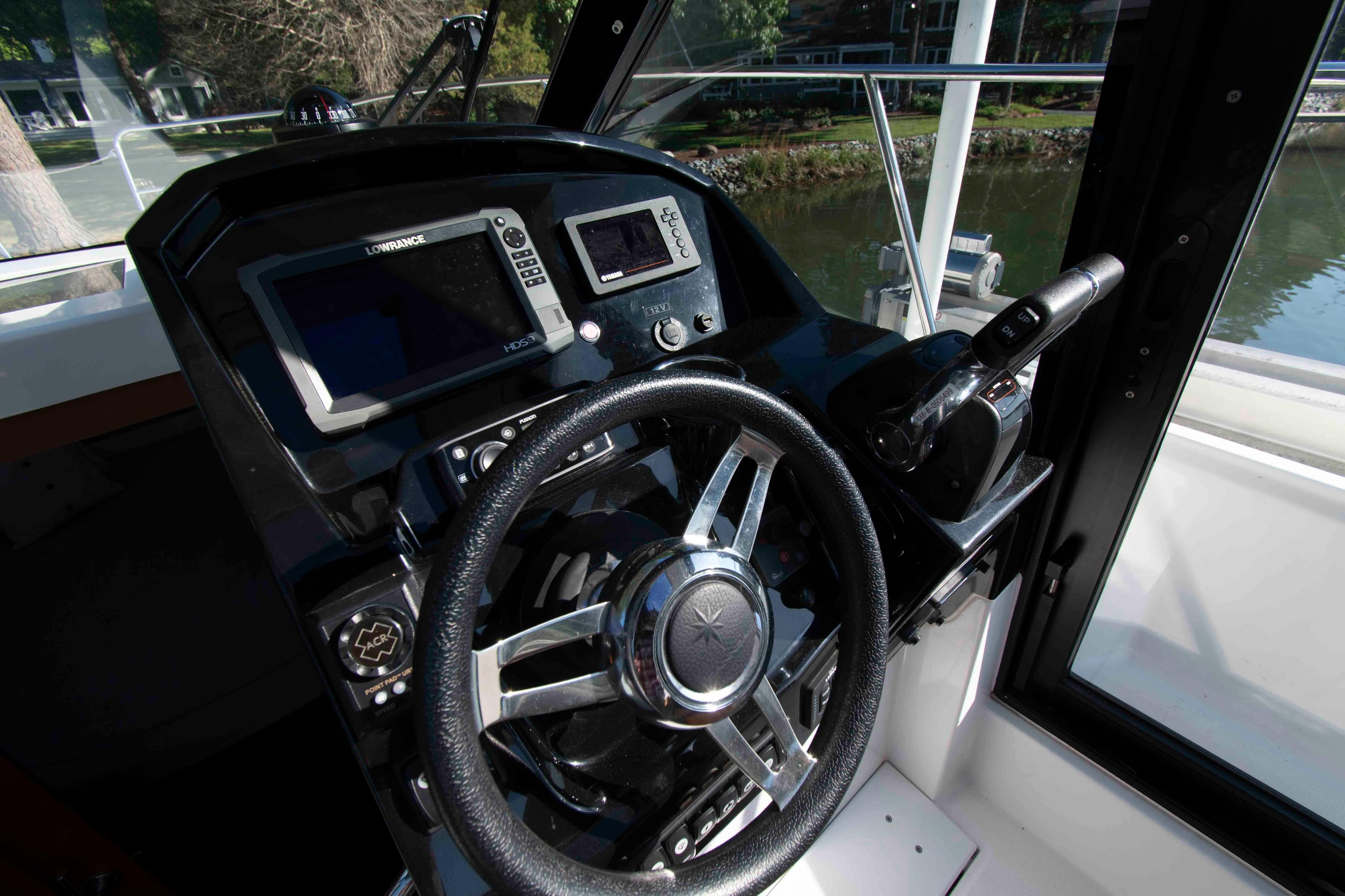 Cockpit of 2017 Jeanneau NC 895 boat with steering wheel and navigation controls.