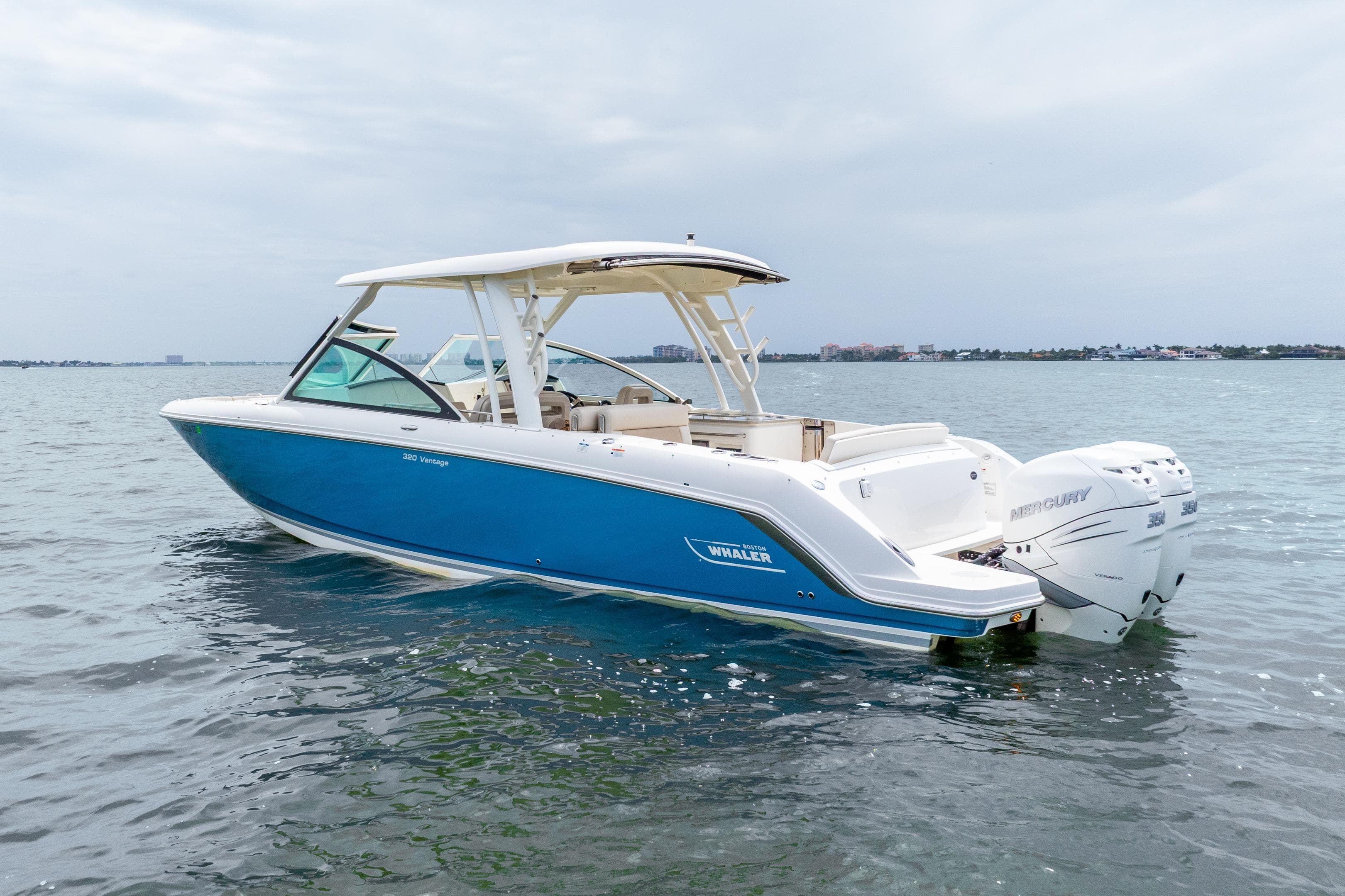 2017 Boston Whaler 320 Vantage boat on water, featuring sleek blue and white design.