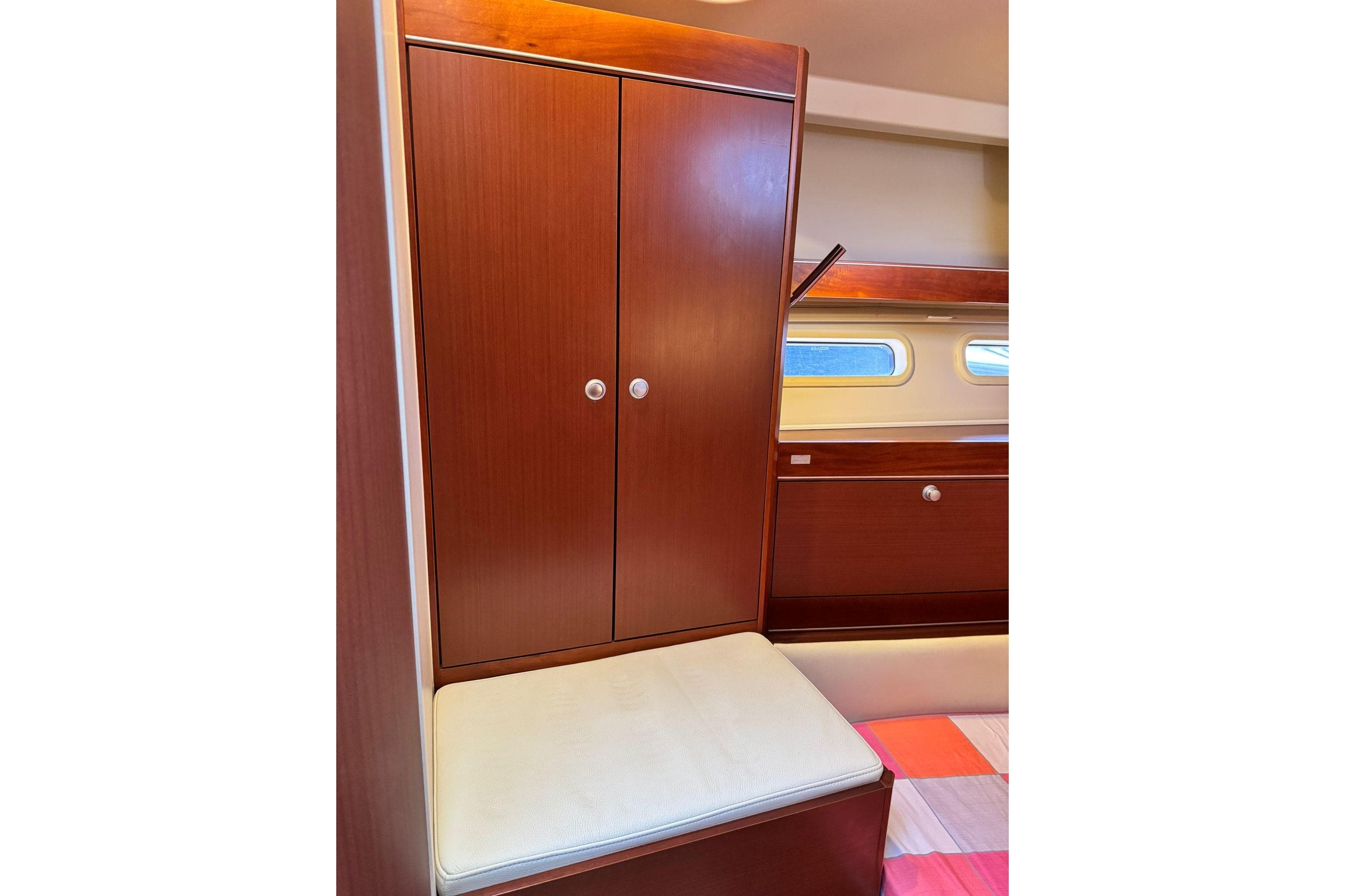 Interior of 2014 Hanse 575 yacht with wooden cabinetry and cushioned seating.